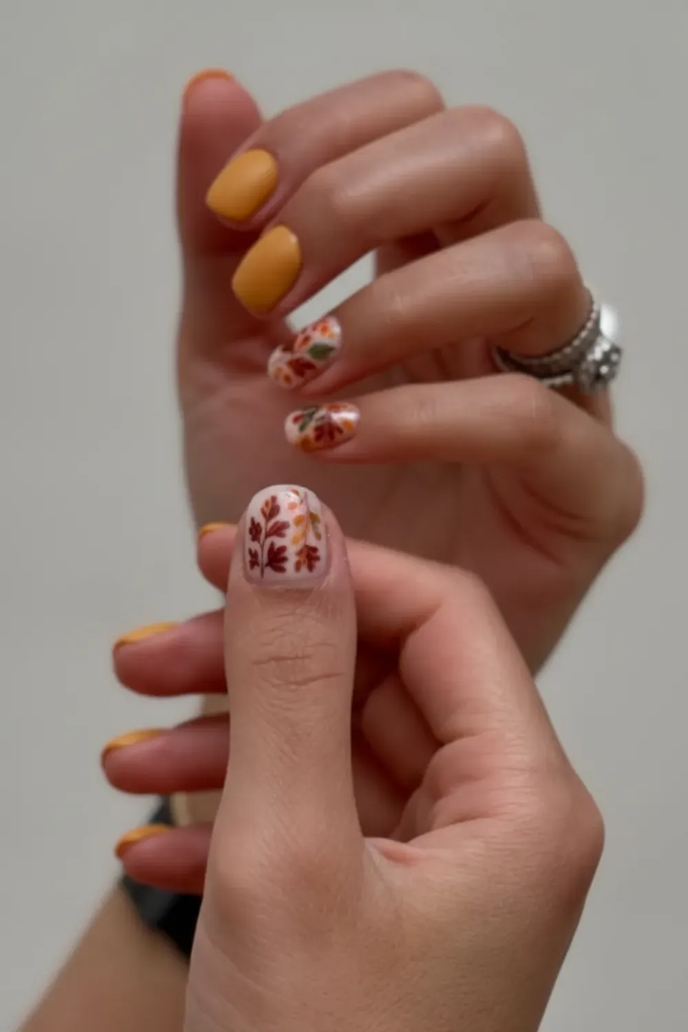 Mustard Yellow Nails with Floral Accents - Bright mustard yellow nails with subtle floral accents, perfect for the fall season.