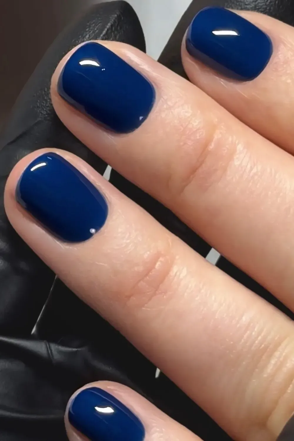Glossy navy blue nails with a sophisticated look