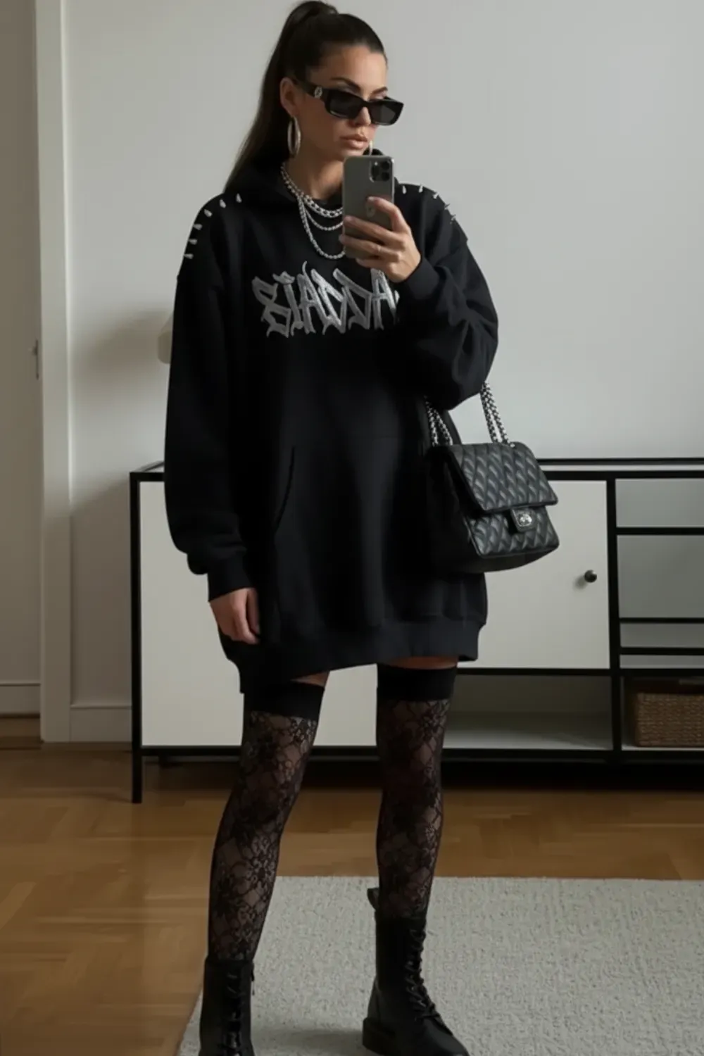 Oversized Hoodie Meets Thigh-High Boots - Oversized graphic hoodie worn as a dress with thigh-high boots and sheer black stocking