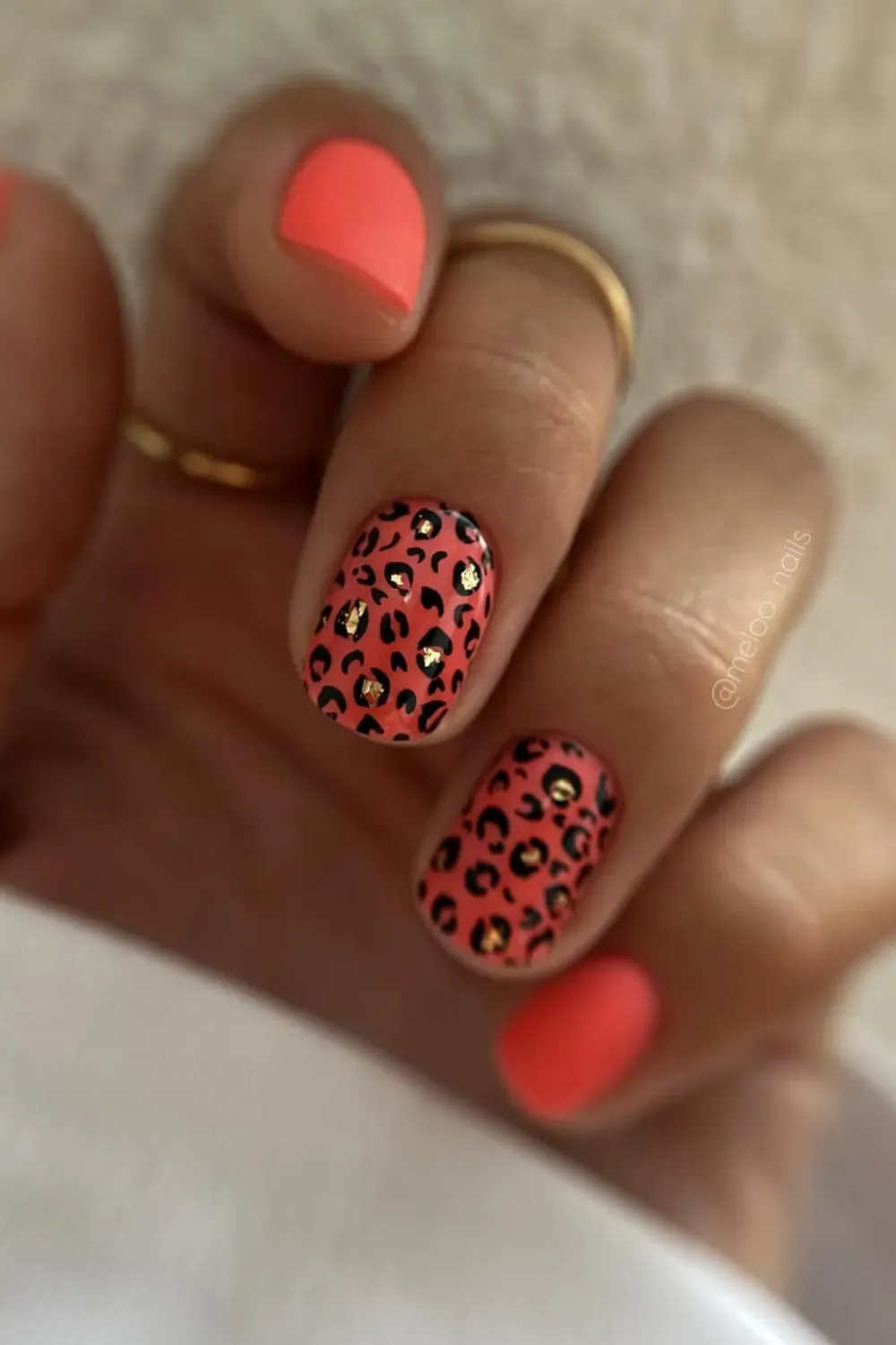 Bold Leopard Print Nails  - Bold leopard print nails with coral background, black spots, and gold studs