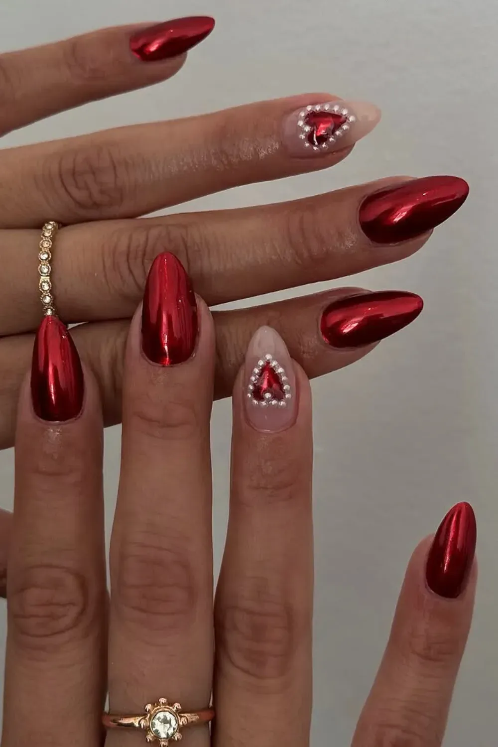 Red Chrome Glam Nails - Glamorous red chrome nails with heart accents, perfect for an elegant fall look