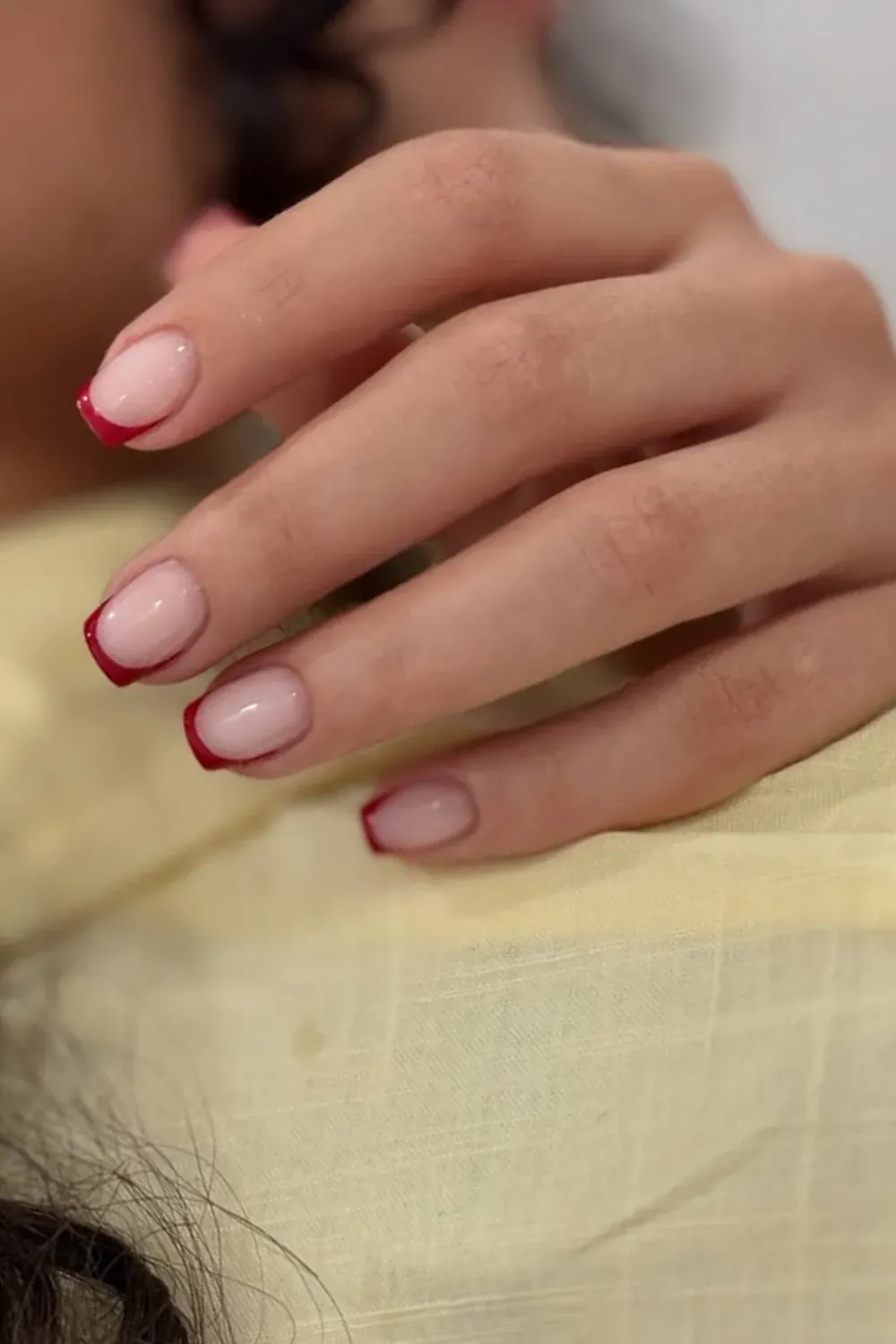 Red French Tips - Soft nude nails with bold red French tips, offering a pop of color and elegance, perfect for a stylish and modern look.