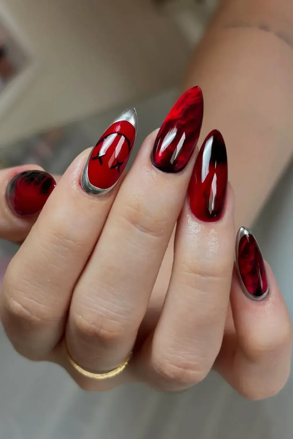 Red Marble Nail Art - Bold red marble design with black accents, giving a modern and edgy look