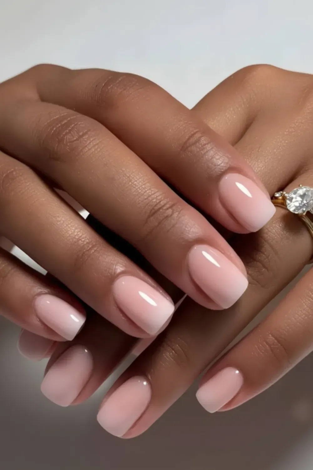 Short nails with a soft ombre gradient from white to pink, offering a subtle yet elegant look.