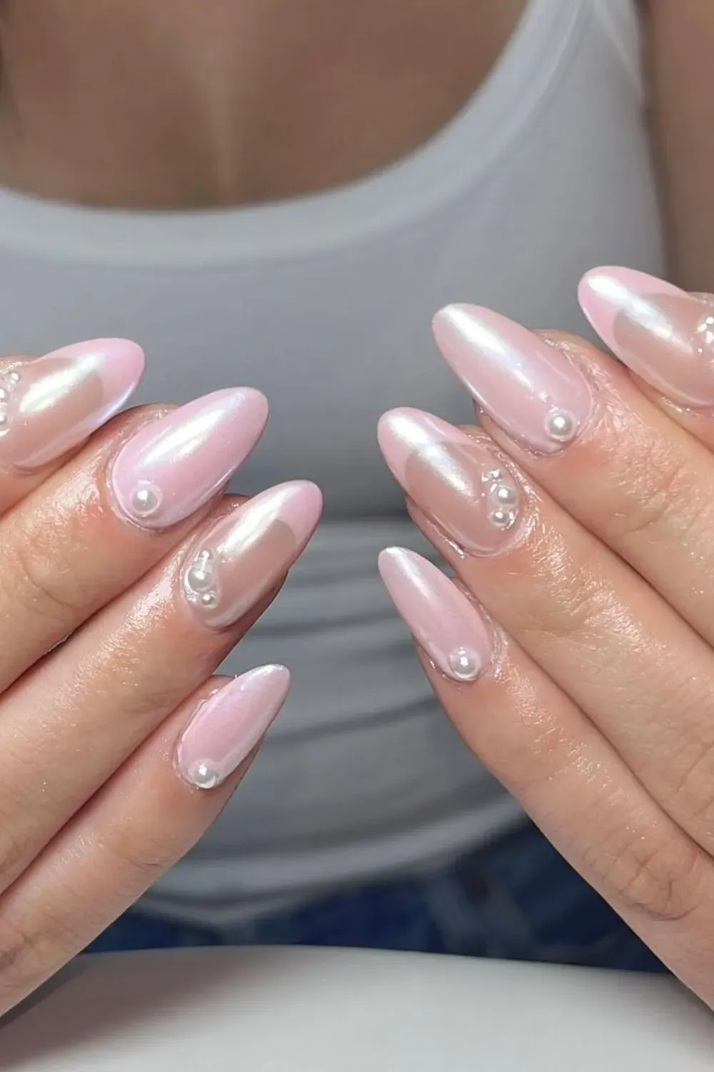  Soft pink chrome nails with pearl accents for a feminine touch