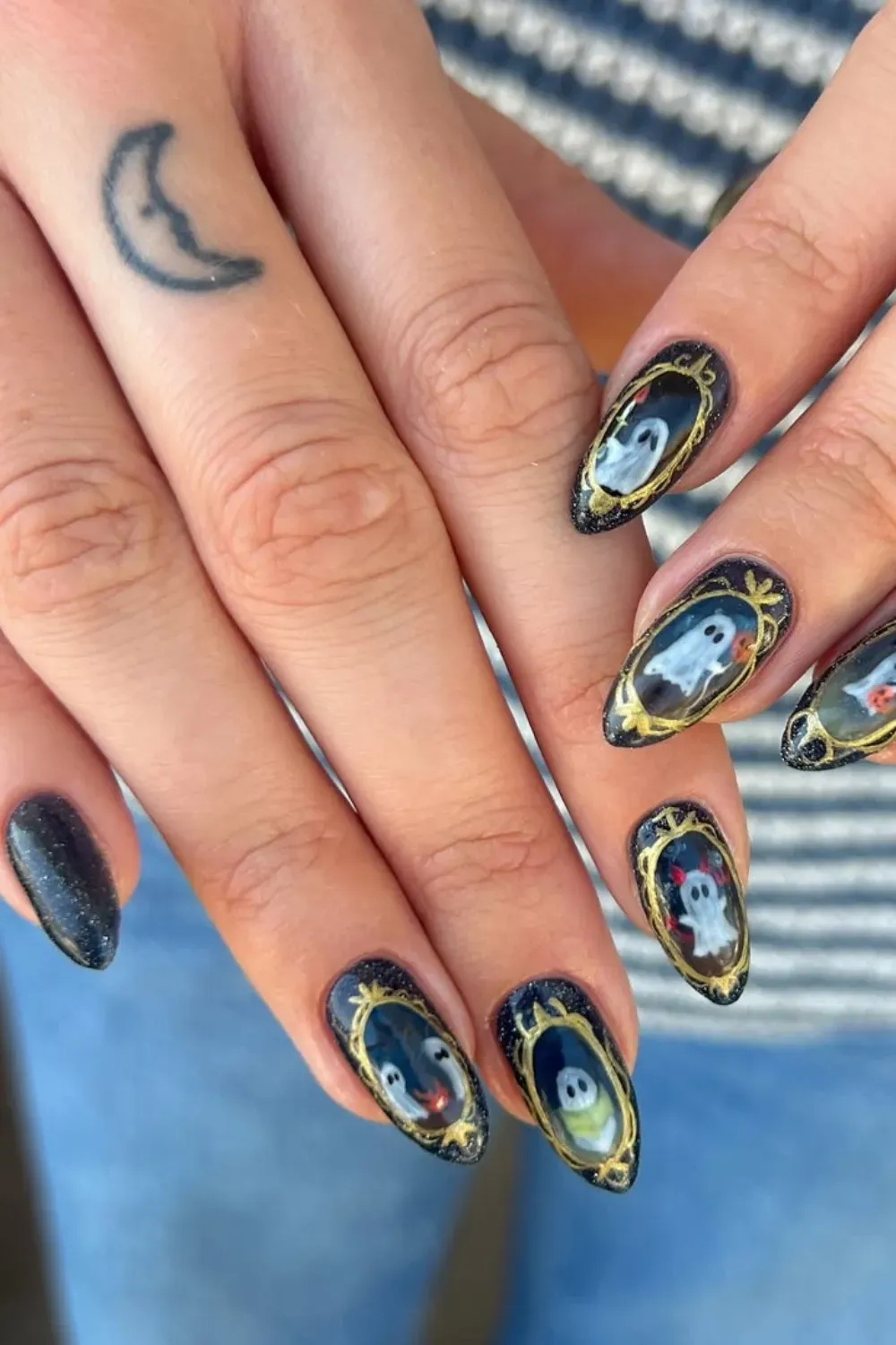 Spooky Ghost Halloween Nail Art - Halloween nails featuring ghosts in golden frames on a black base with sparkly accents.