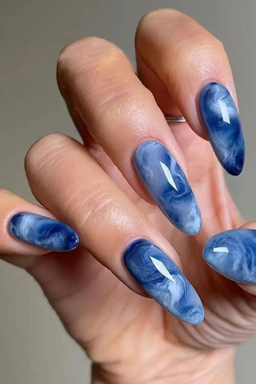 Swirled Marble Blue Nails - Artistic blue marble nails with a unique swirling design, offering a chic and trendy nail art style for the fall season.