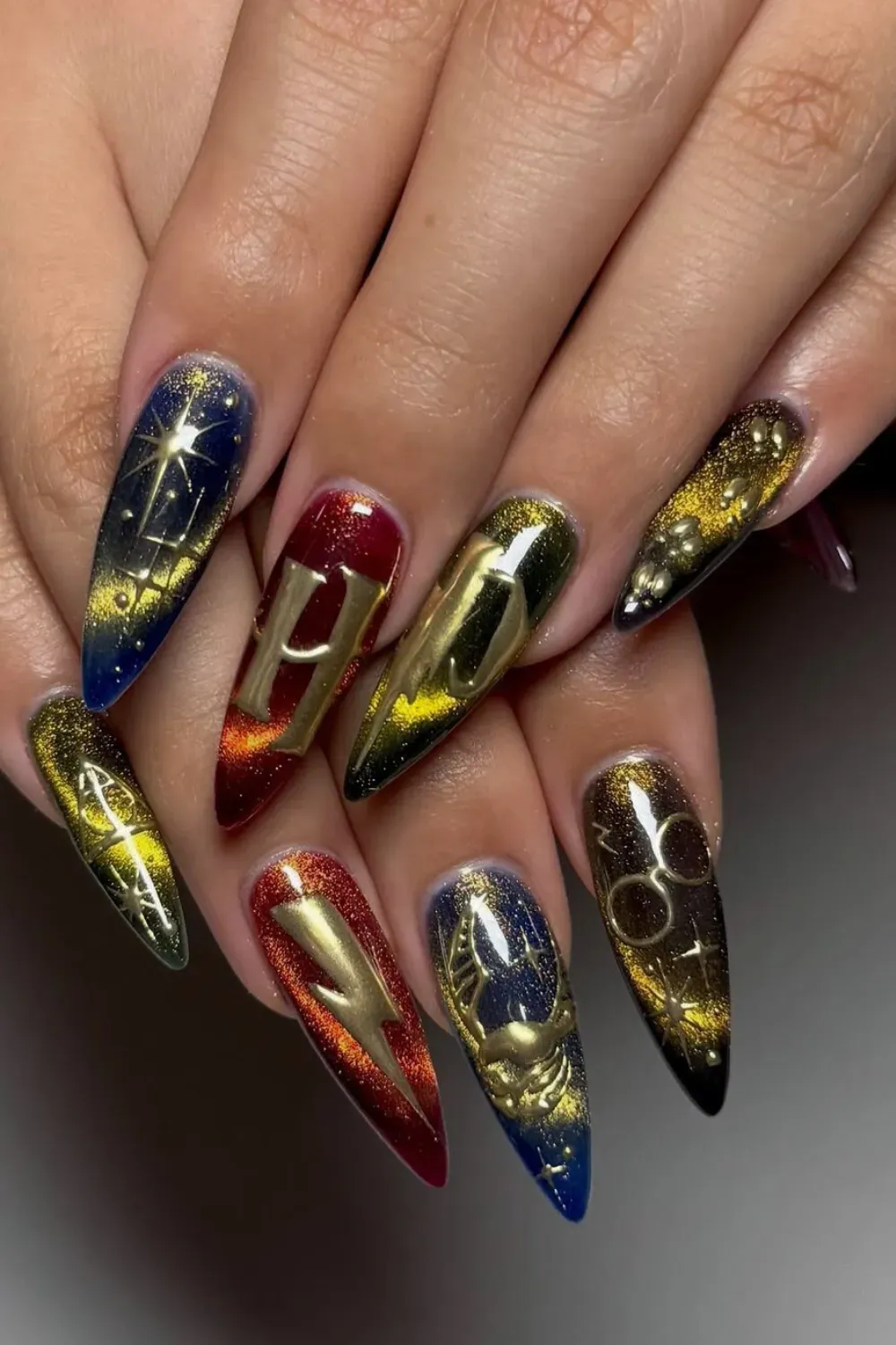 Golden Magic Halloween Nails - Golden, metallic nail art with celestial designs including stars and moons for a magical Halloween look