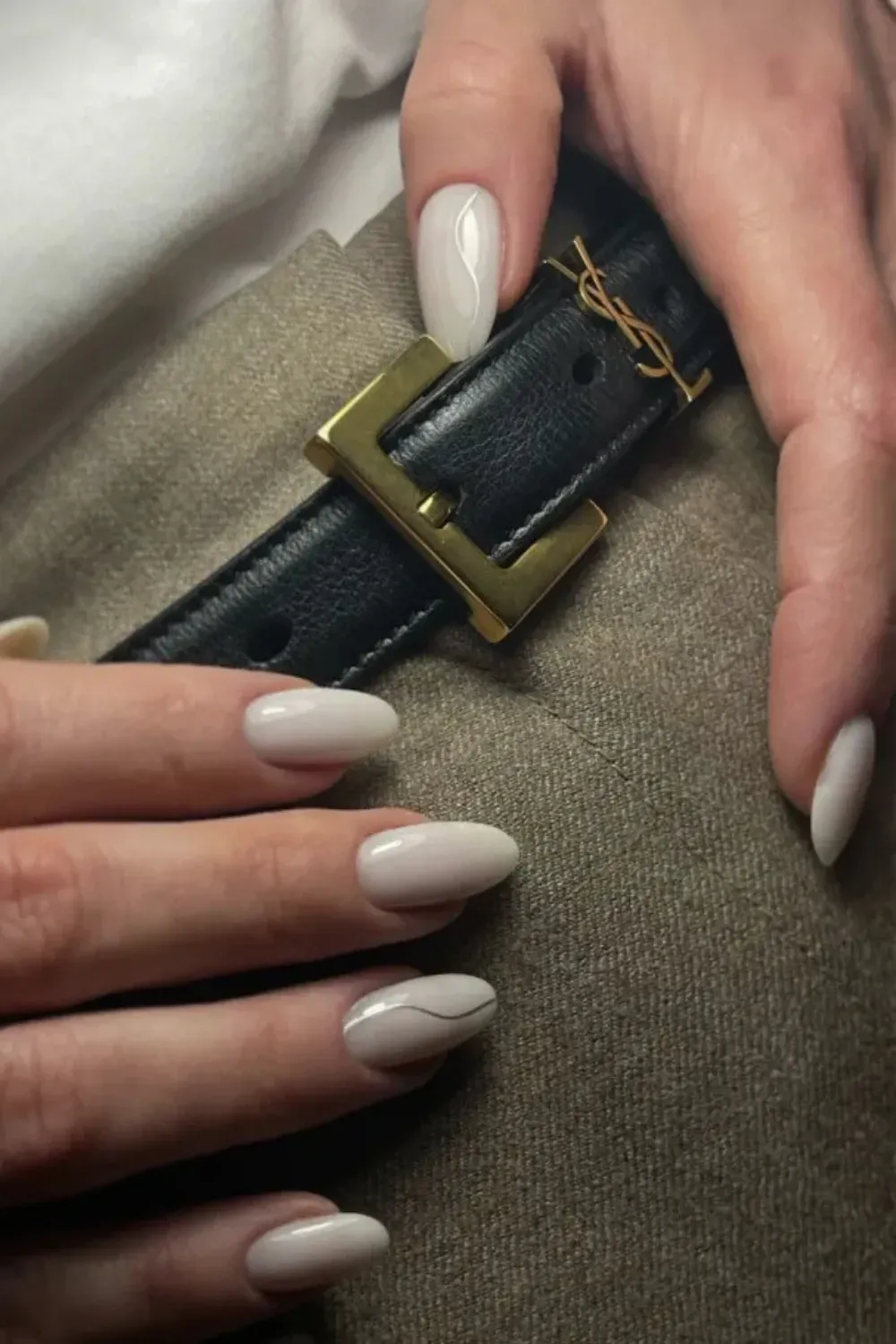 Quiet Luxury White Milky Nails with Silver Line Art - Long almond nails painted with a creamy white milky polish, accented with a single thin, metallic silver wave line on two fingers