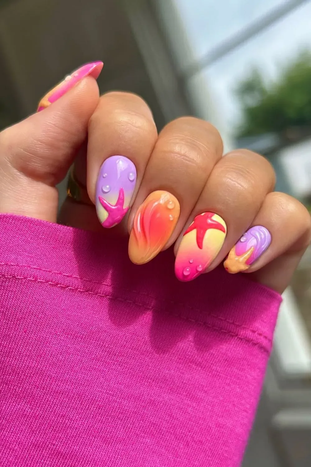 Colorful 3D summer nail art with glossy textures and starfish design.