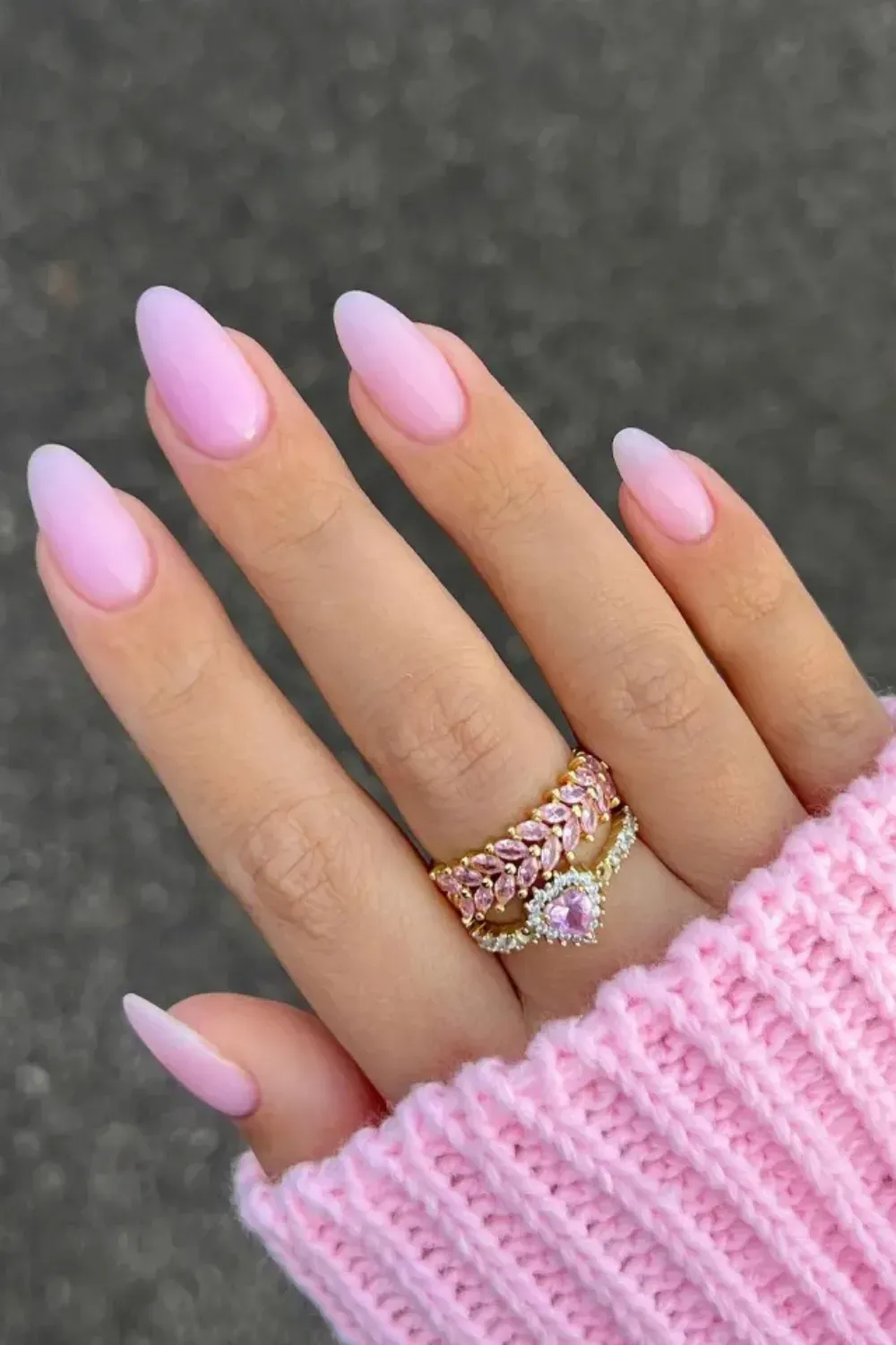 Pink Milky Almond Ombre Nails - Long almond-shaped nails with a soft, milky pink polish that fades to a lighter color at the tips.