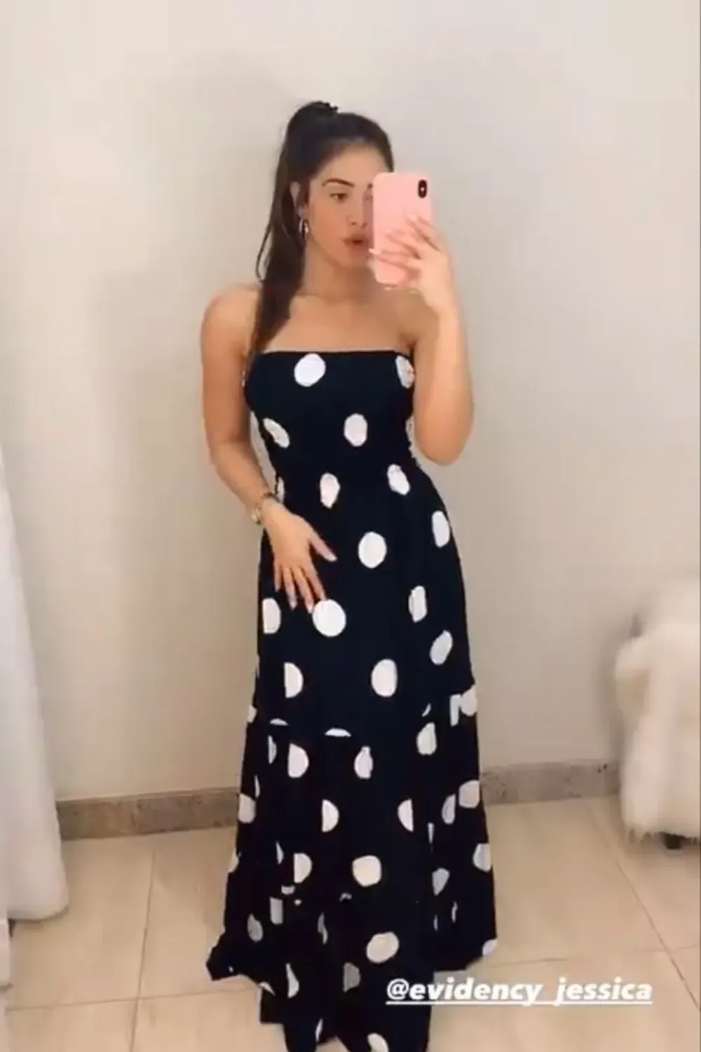 Navy Blue Strapless Polka Dot Maxi Dress	Woman wearing a casual navy blue strapless maxi dress with large white polka dots and a tiered skirt.