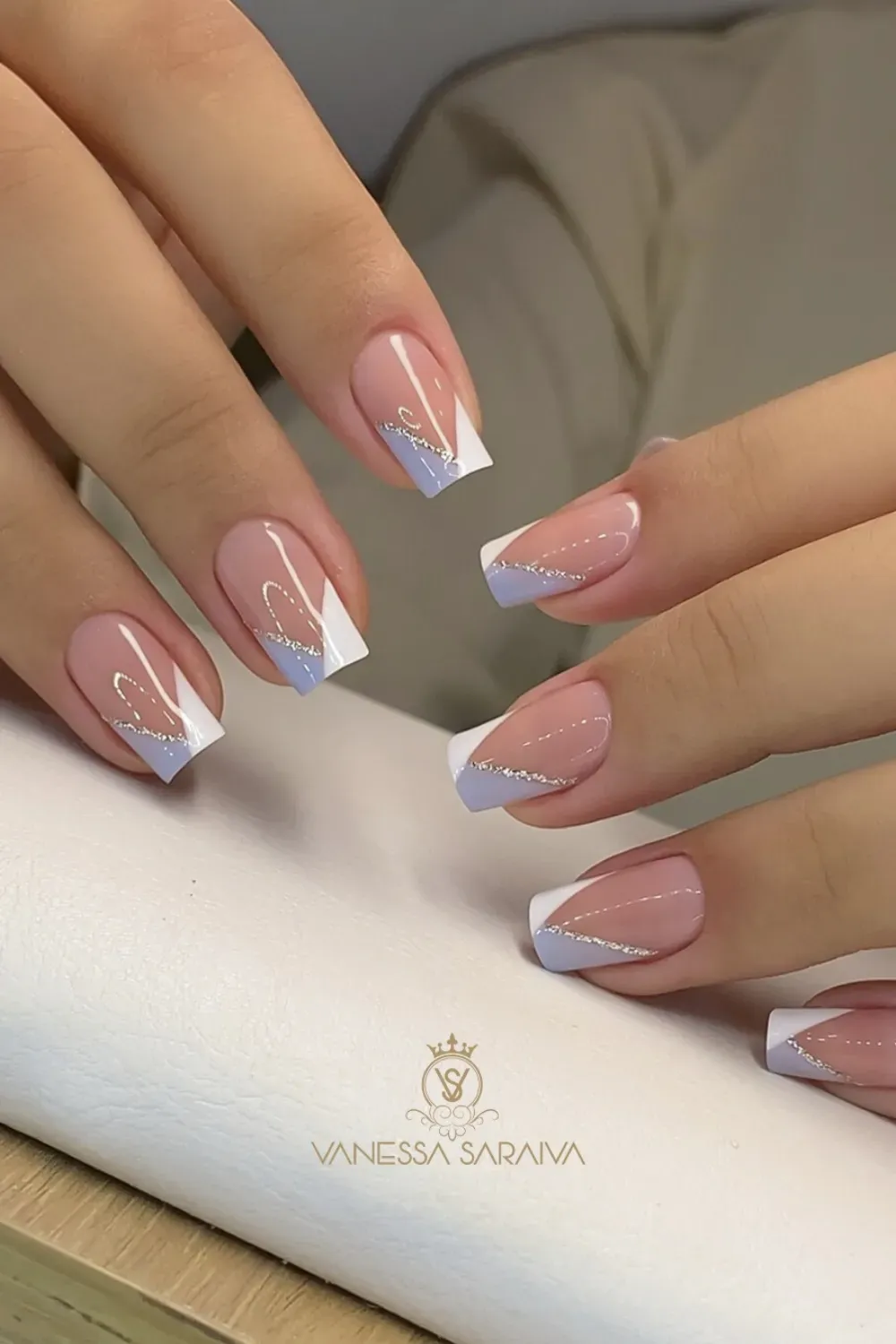 Medium square nails with a V-cut angled French tip, alternating white and pastel purple with a silver glitter line.
