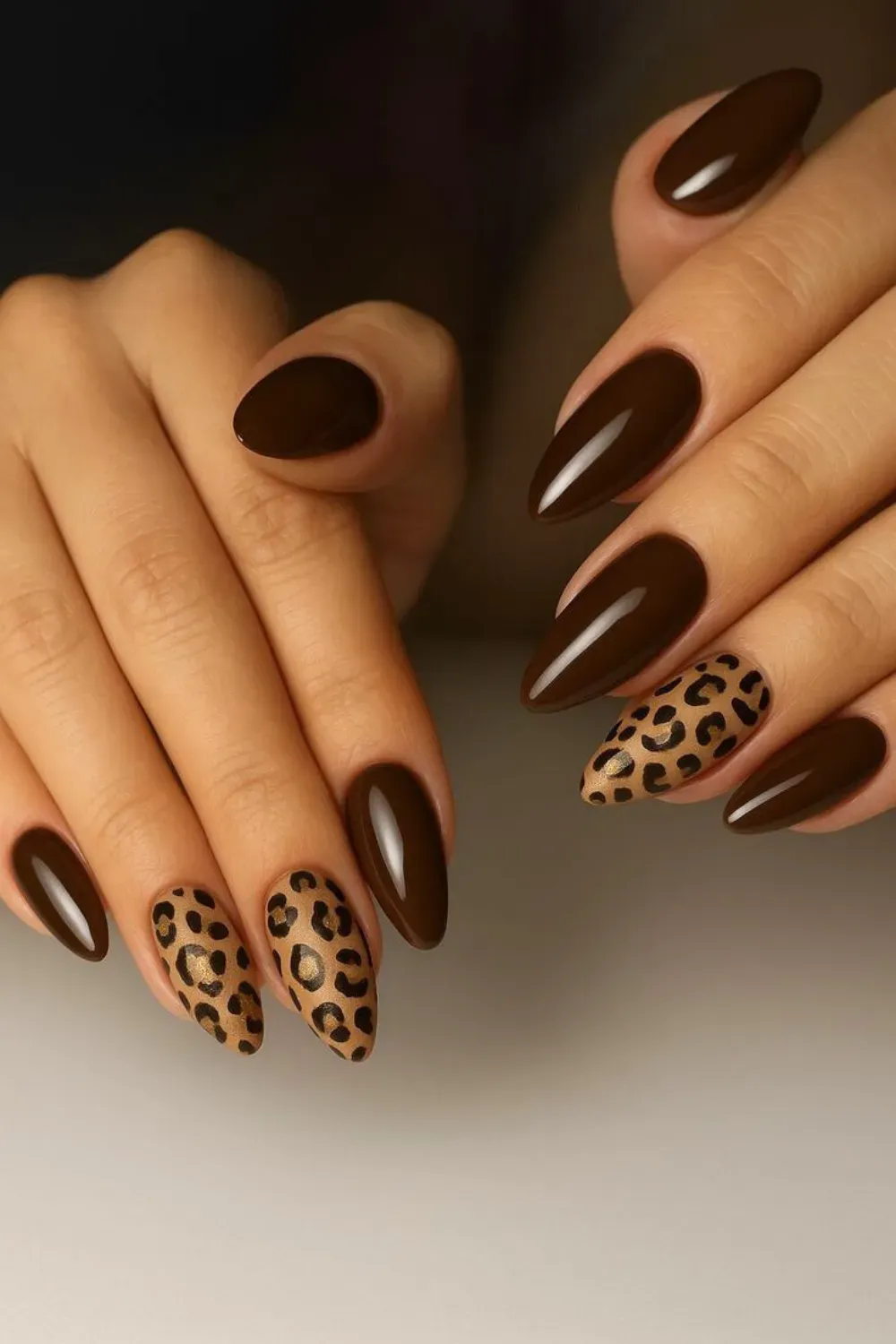 Animal Print Nails - Dark brown nails with a beige leopard print accent nail, adding a bold, wild touch to the elegant brown base