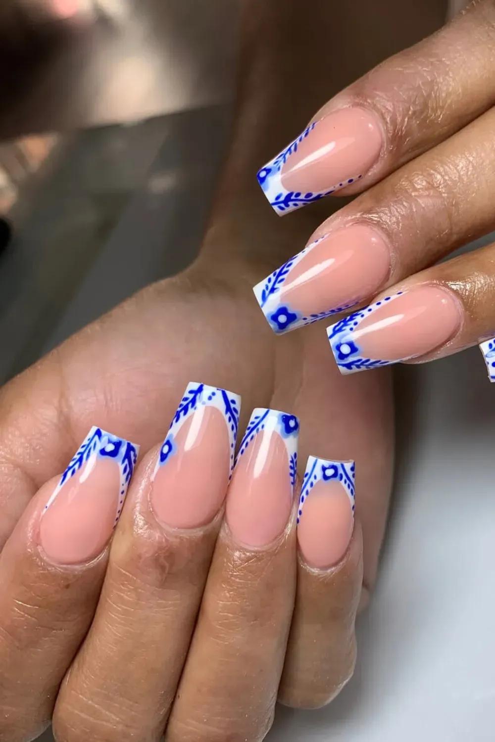Blue and White Porcelain Pattern French Manicure Coffin-shaped nails with a French tip design featuring intricate blue and white floral porcelain-inspired patterns.