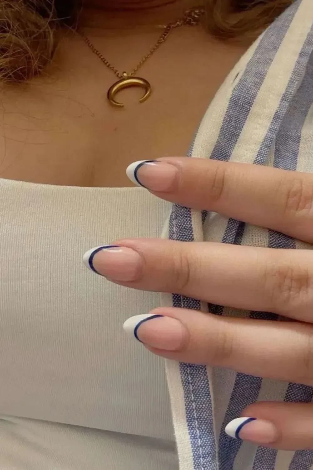 Navy Double French Tip Nails - Close-up of nails with double navy and white French tips on a nude base