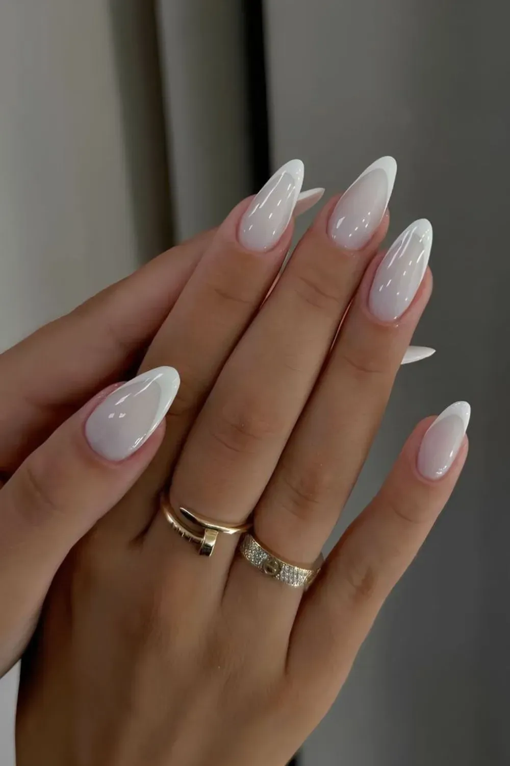 Abstract Layered White Nails - Almond nails with thin, sweeping white curved lines on a nude base