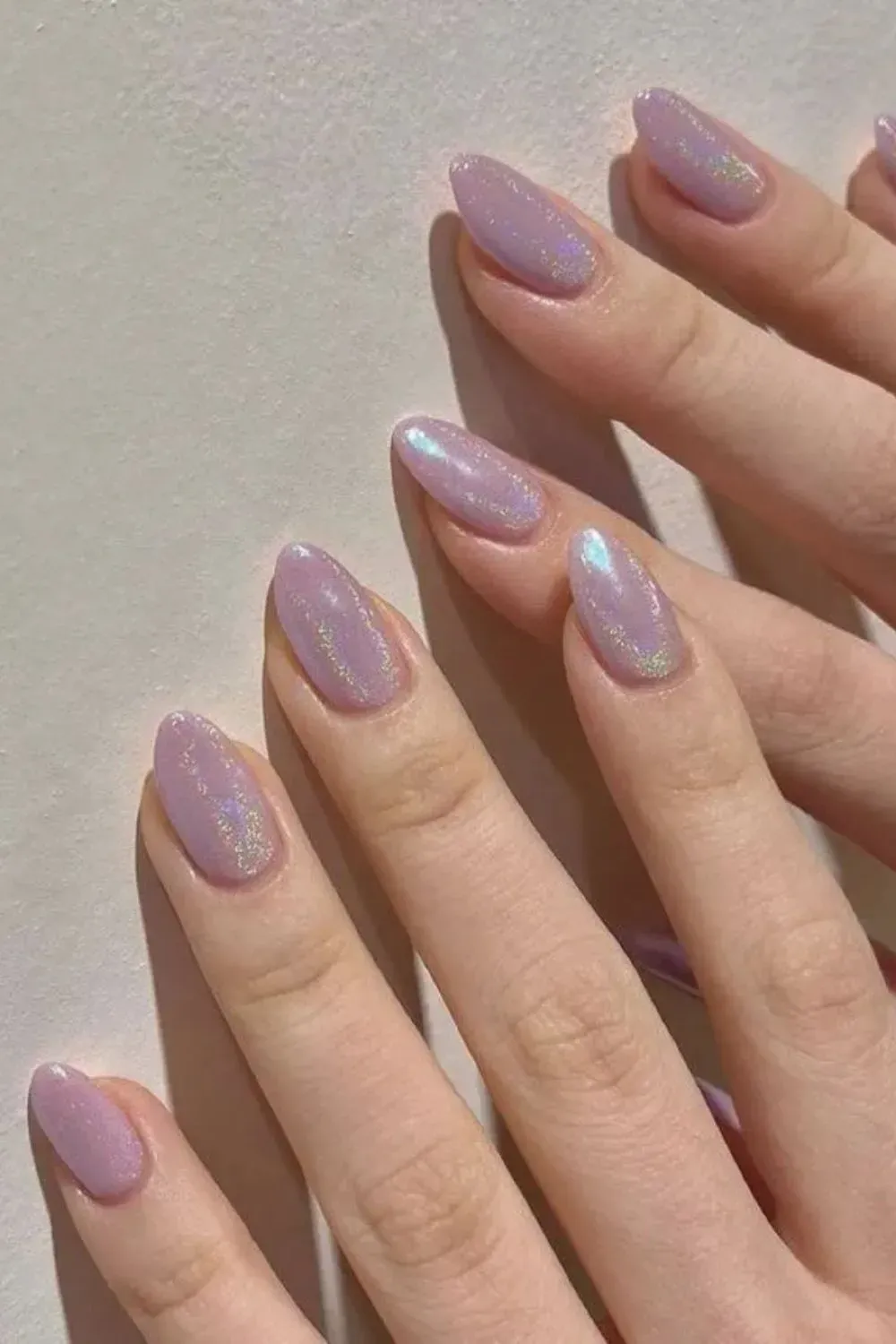 Lilac Iridescent Almond Nails - Almond-shaped lilac nails with a sparkly holographic glow