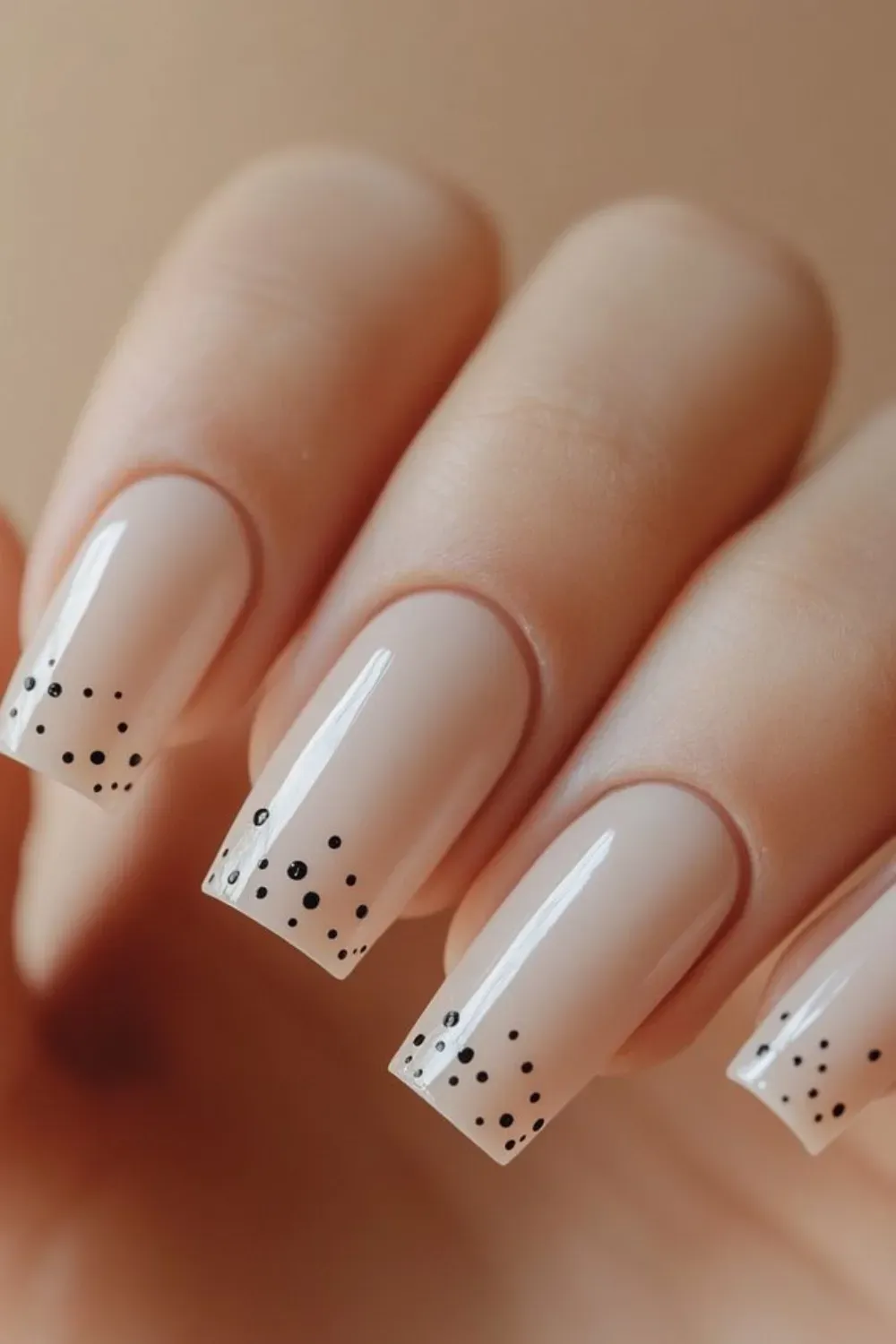 Nude Micro-Dot French Manicure - Square-shaped natural nails in a glossy nude color with small black polka dots clustered on the tips
