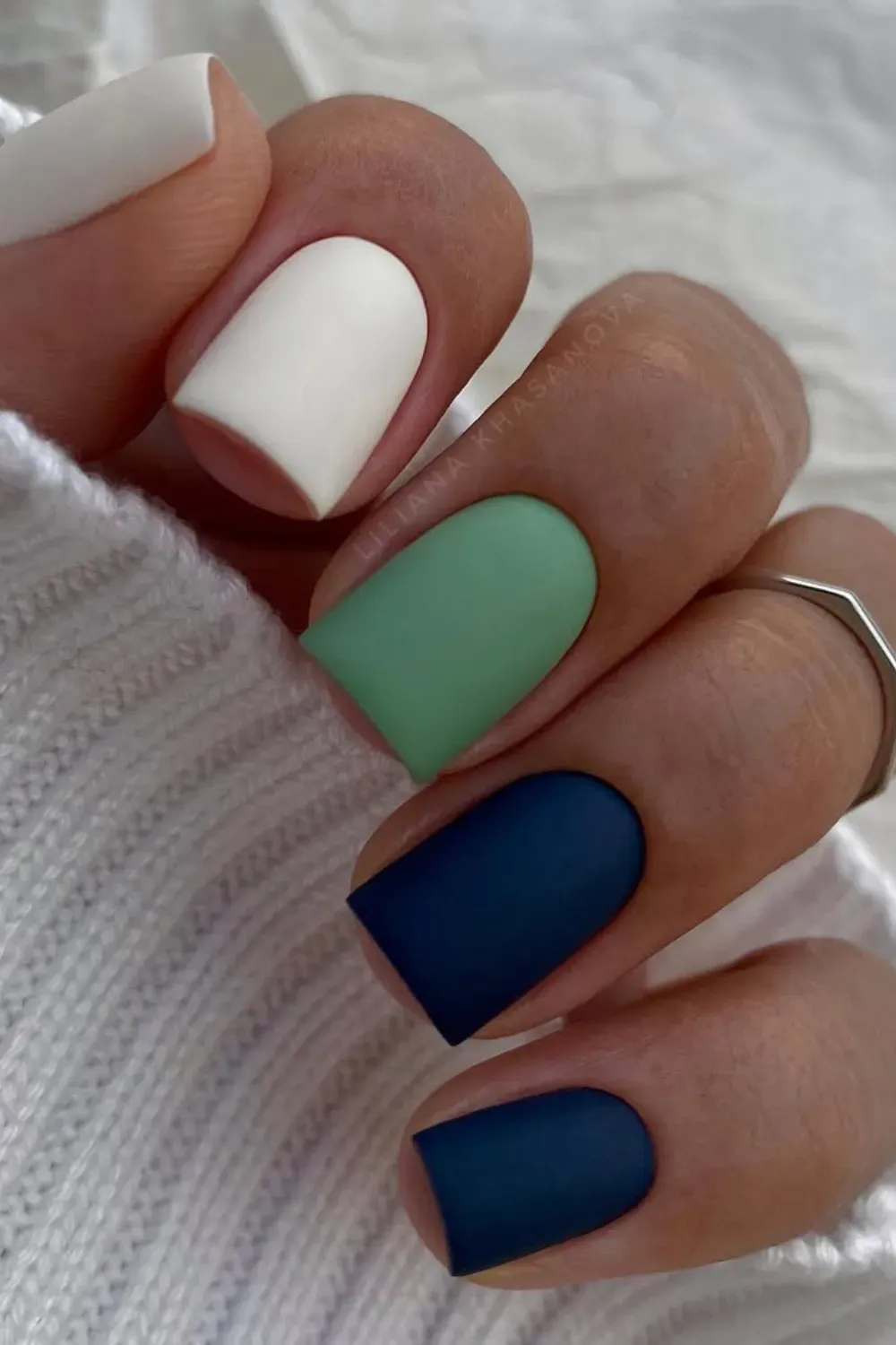 Matte color-blocked nails with pastel and dark tones - Minimalistic matte color-blocked nails with white, green, and navy blue for a clean and modern look.