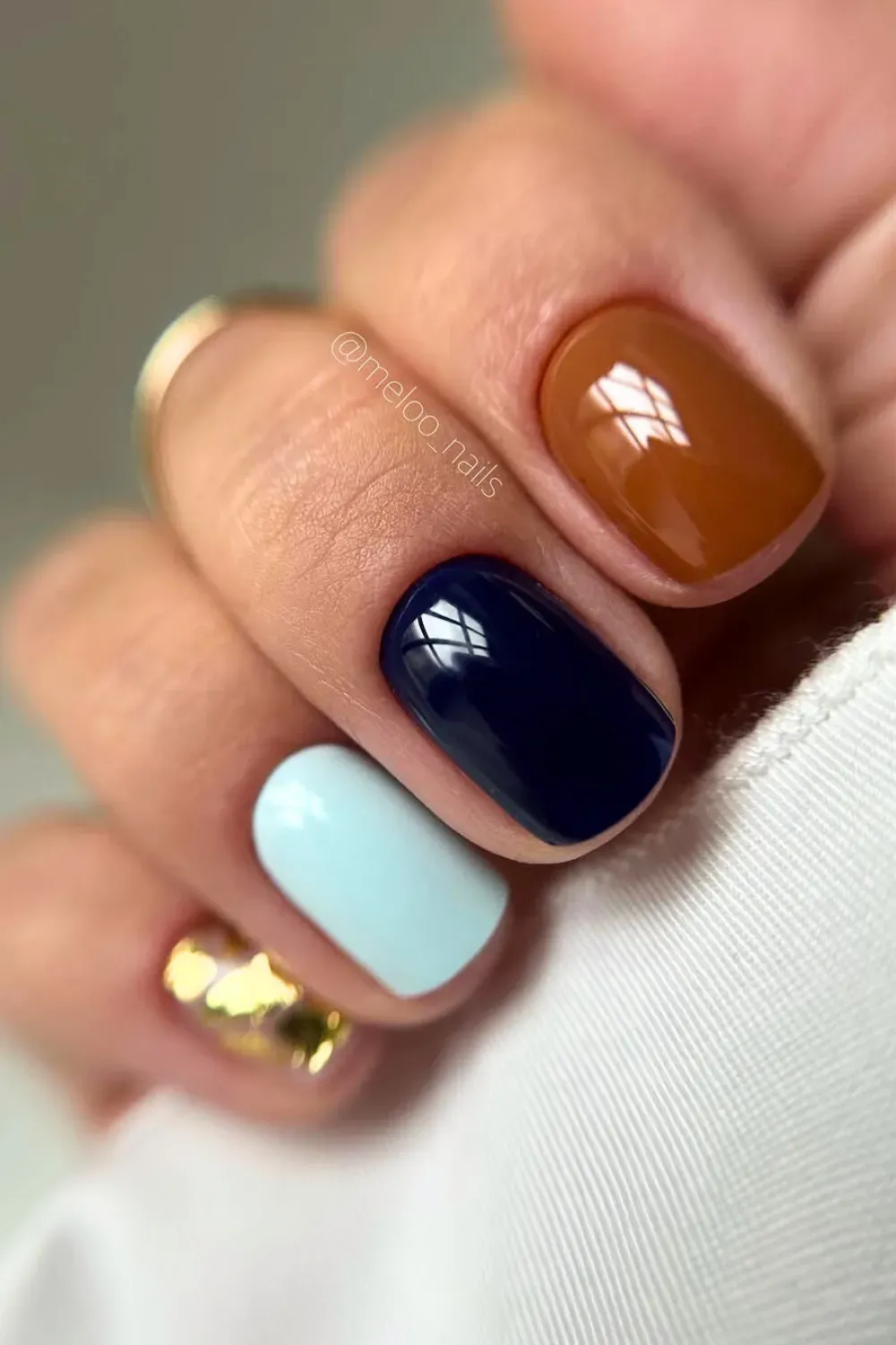 Mixed Color Manicure with Blue, Brown, and Gold Square nails with a mixed manicure palette: navy blue, light blue, glossy brown, and a gold foil accent nail.