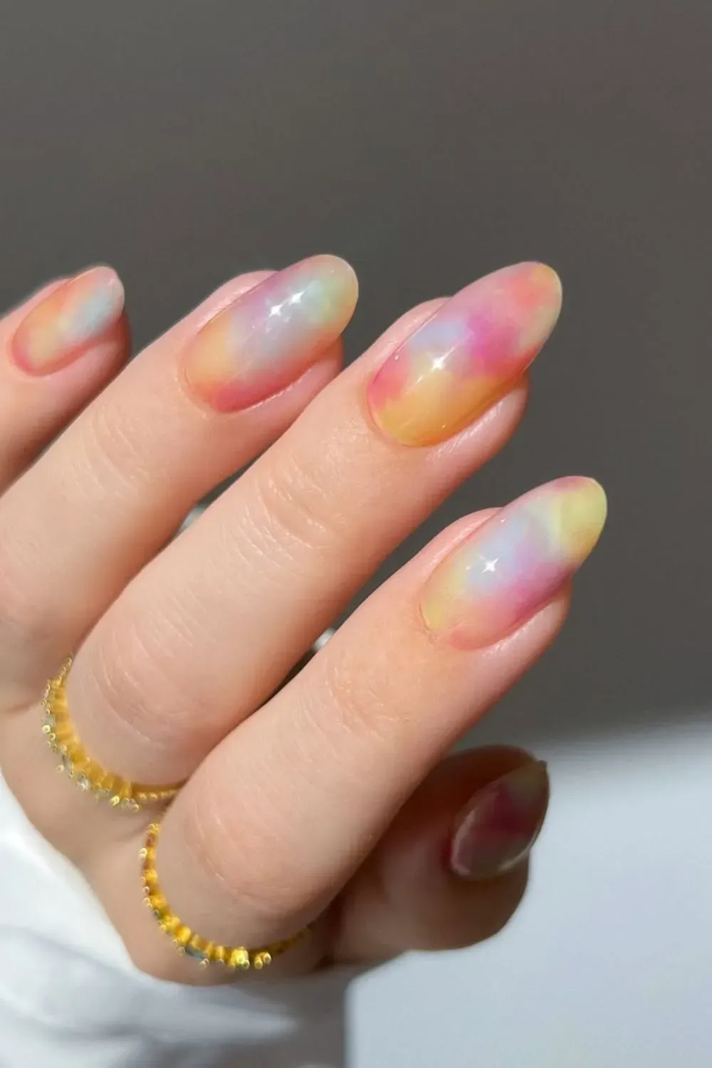 Watercolor-inspired pastel nails with a high-shine glass effect.