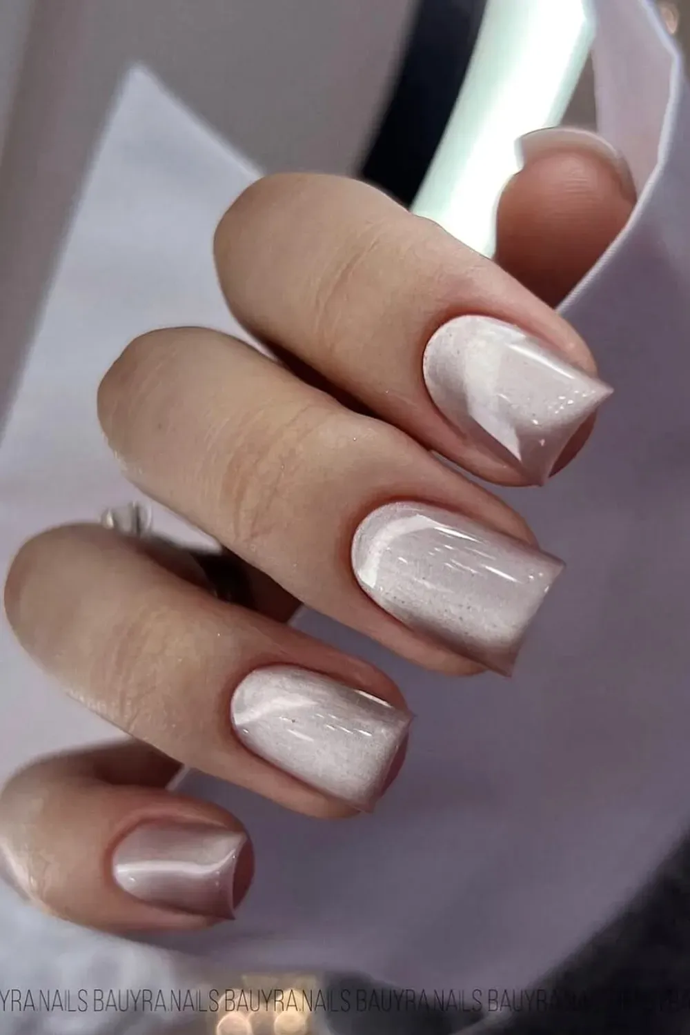 Light, sheer nude nails with a subtle, silky white crystal cat eye shimmer on a square shape.