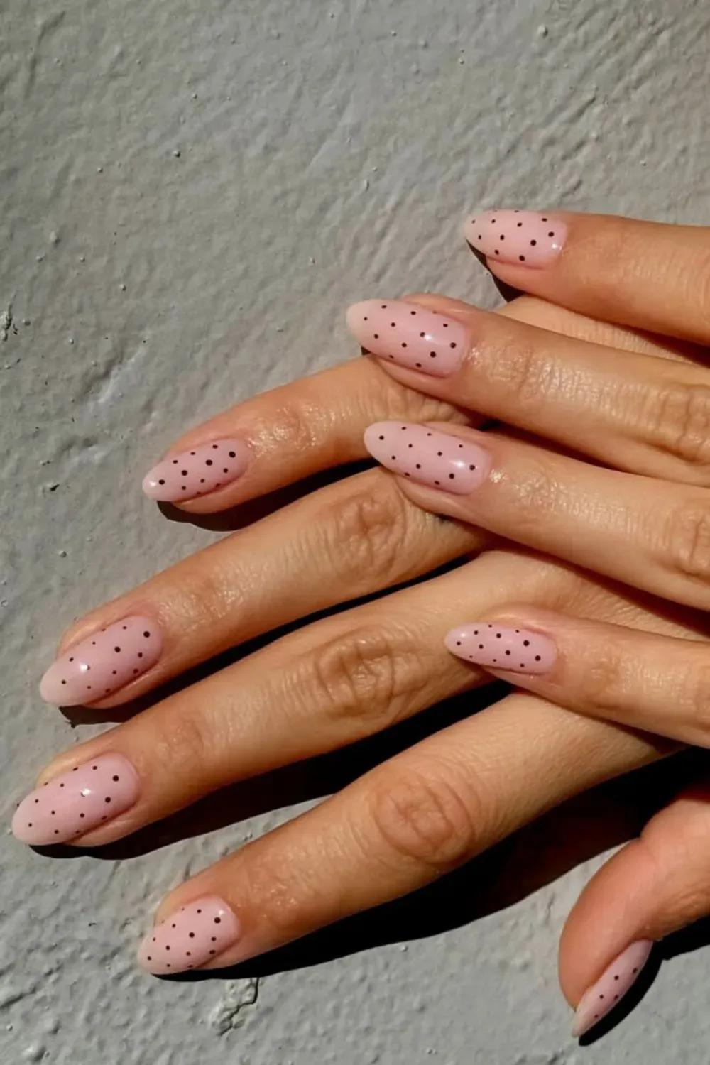 Tiny Black Polka Dots: Delicate black polka dots scattered over a neutral base, adding a playful yet sophisticated touch to the manicure
