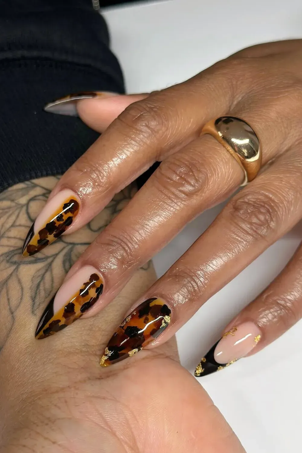 Tortoise Shell French Tips with Gold Flake: French manicure with tortoise shell tips and delicate gold foil flakes for a luxurious twist.