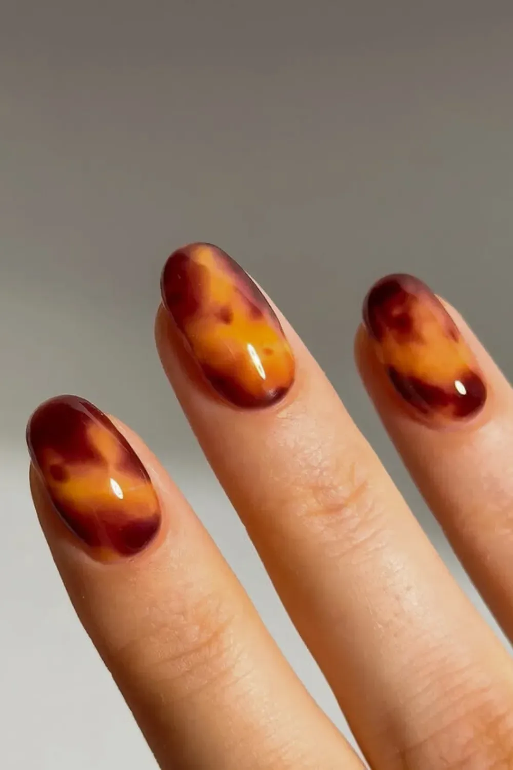 Translucent Tortoise Shell: Elegant nails with a tortoise shell design using amber and brown hues, mimicking the warm, polished look of natural tortoiseshell.