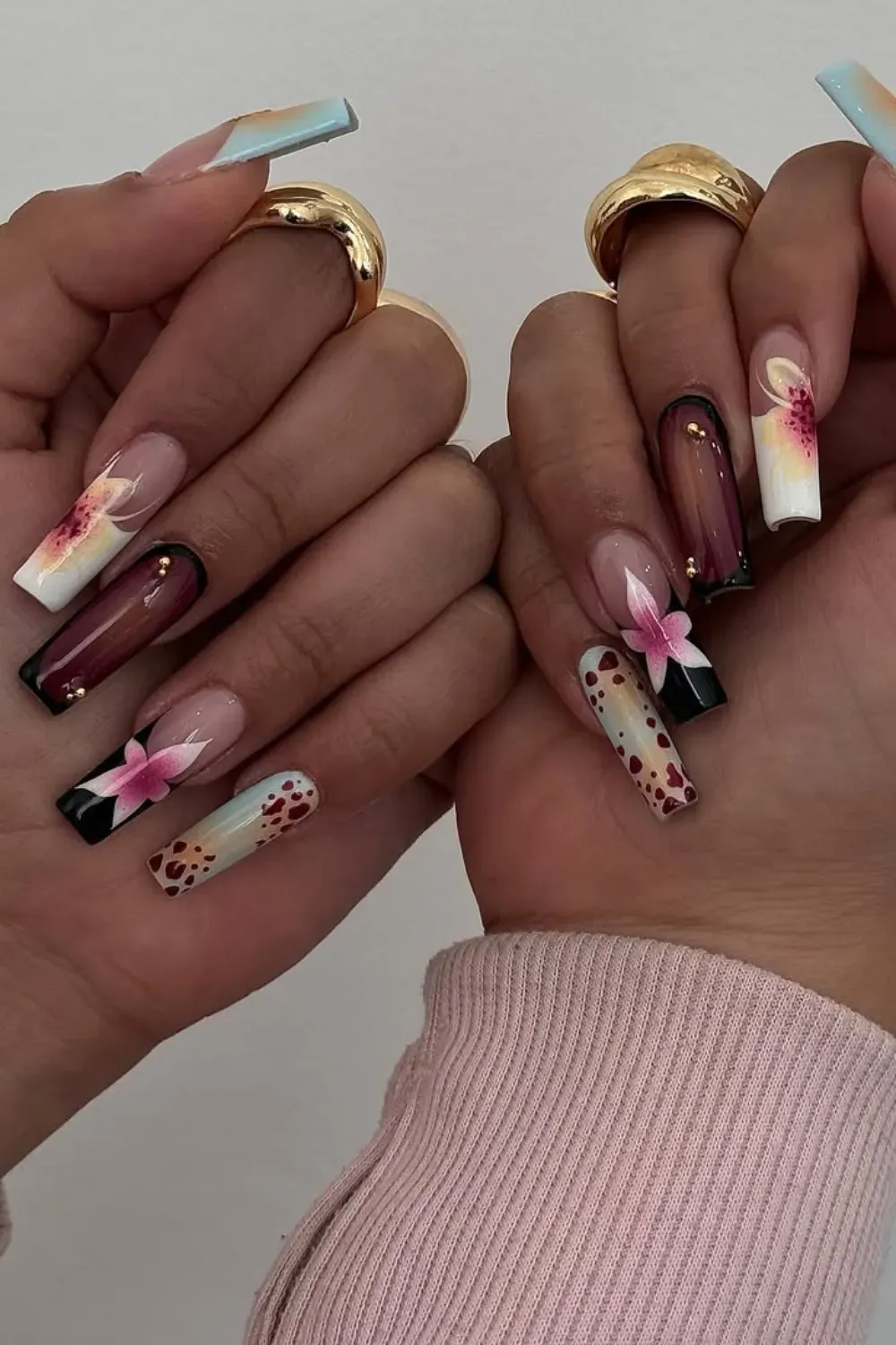 Vibrant floral and abstract nails - A vibrant pastel floral and abstract design featuring light pink, burgundy, and black accents.