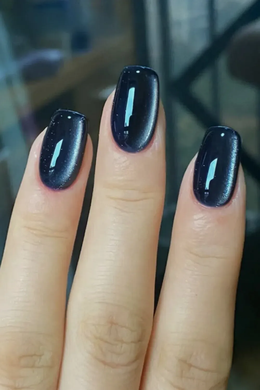 Simple jewel tone deep purple cat eye polish on short nails.