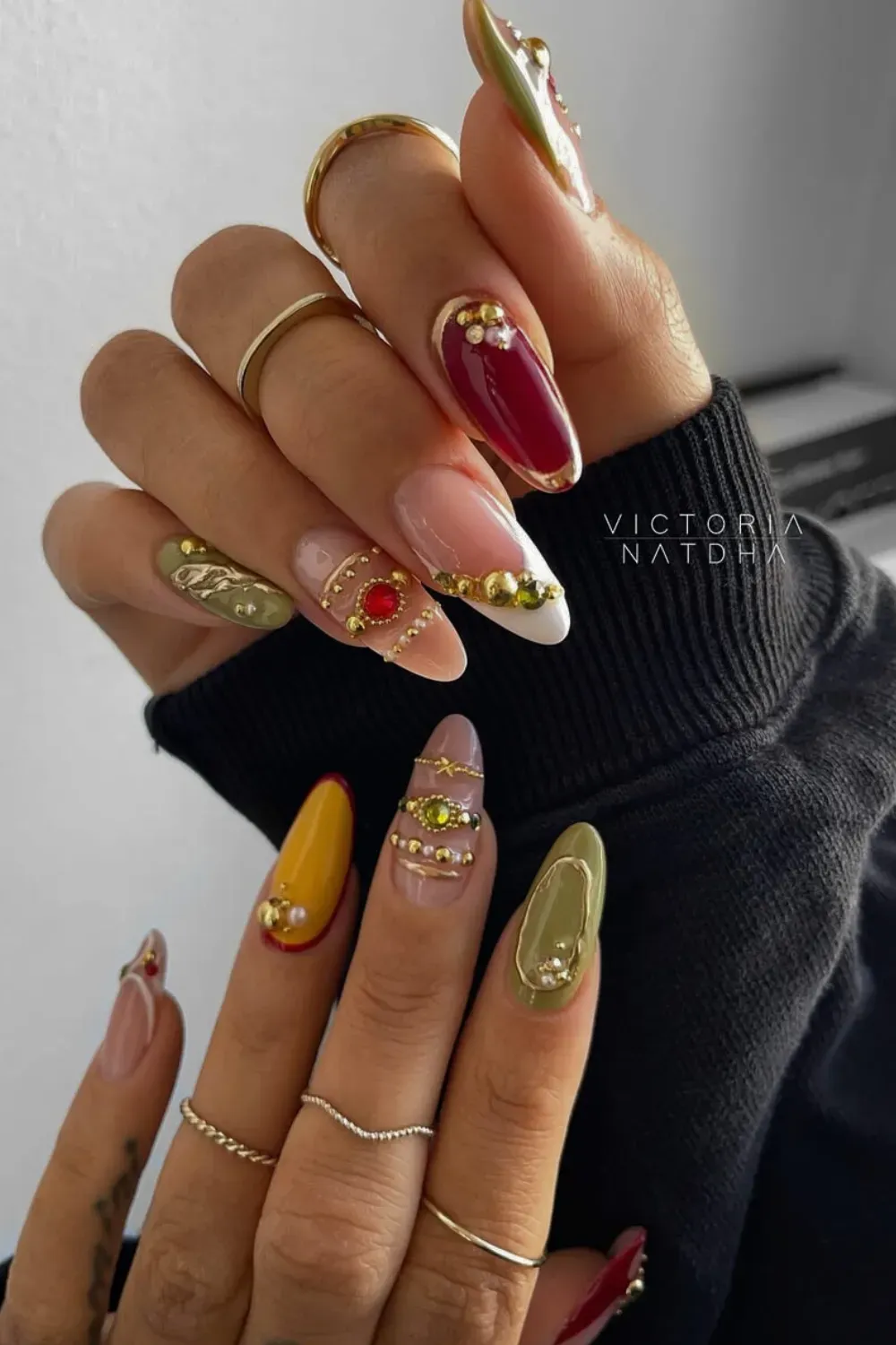 Maximalist Multi-Colored Bangle Nails with Rhinestone Stacks - Vibrant, mixed-media Bangle Nail design in olive green, yellow, and red with multiple stacked gold and rhinestone bands.