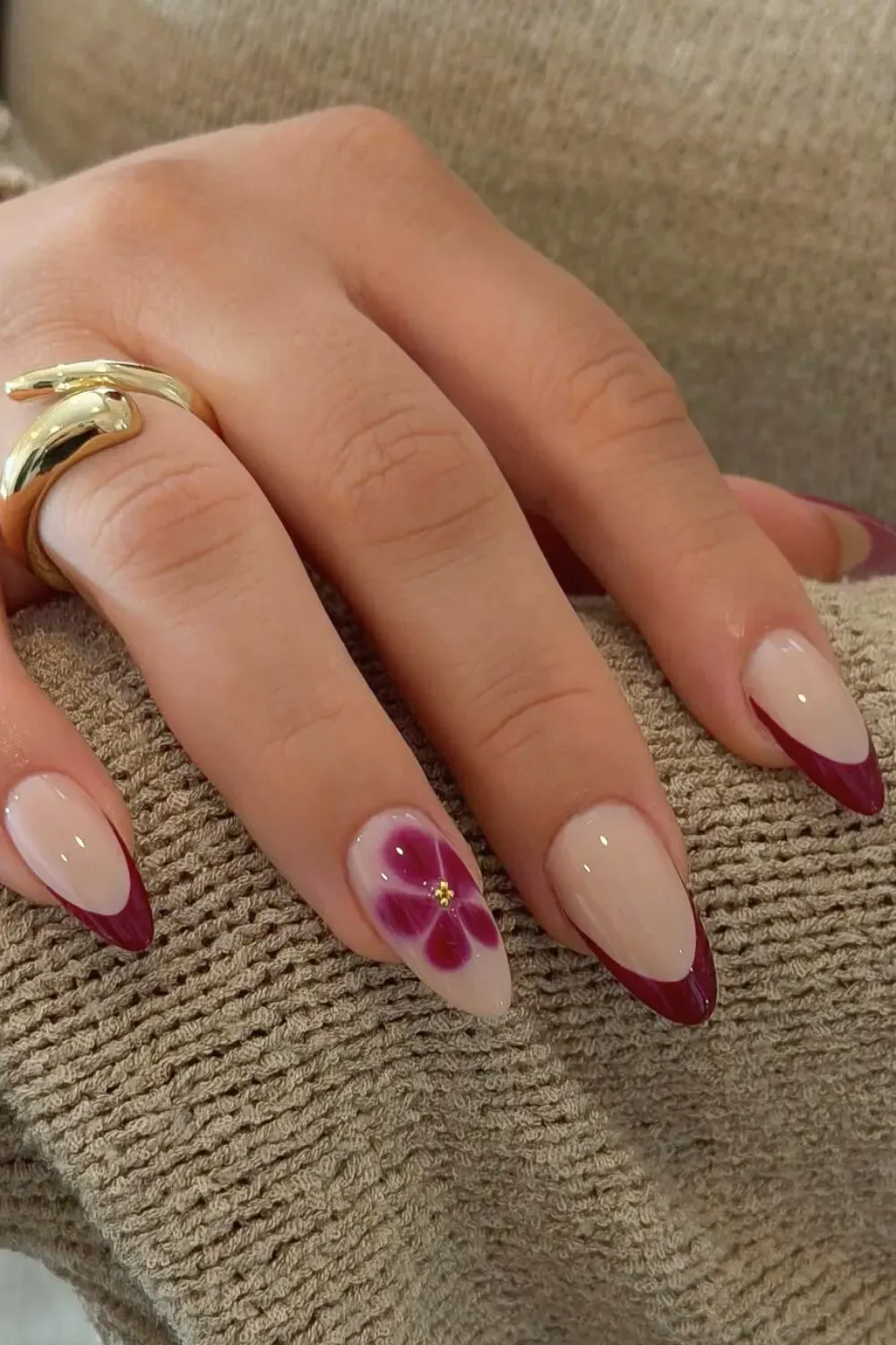 Burgundy Floral Almond French: Almond nails with a burgundy French tip and a delicate floral accent