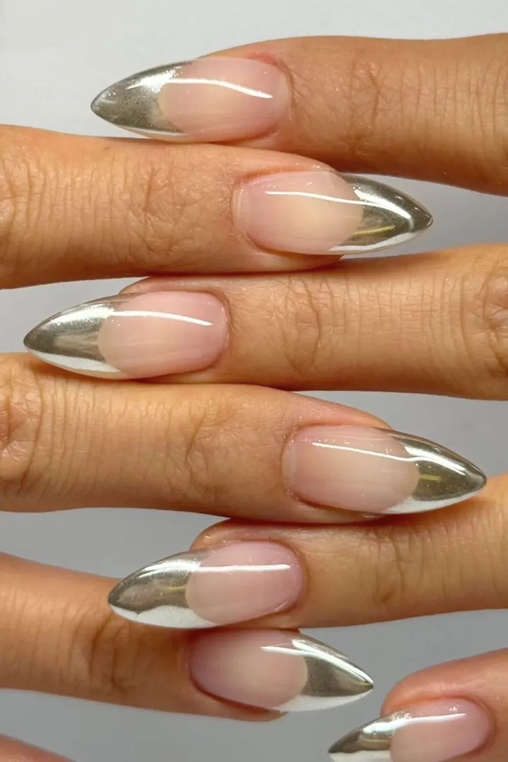 Dazzling Chrome Stiletto French: Stiletto nails with a striking silver chrome French tip
