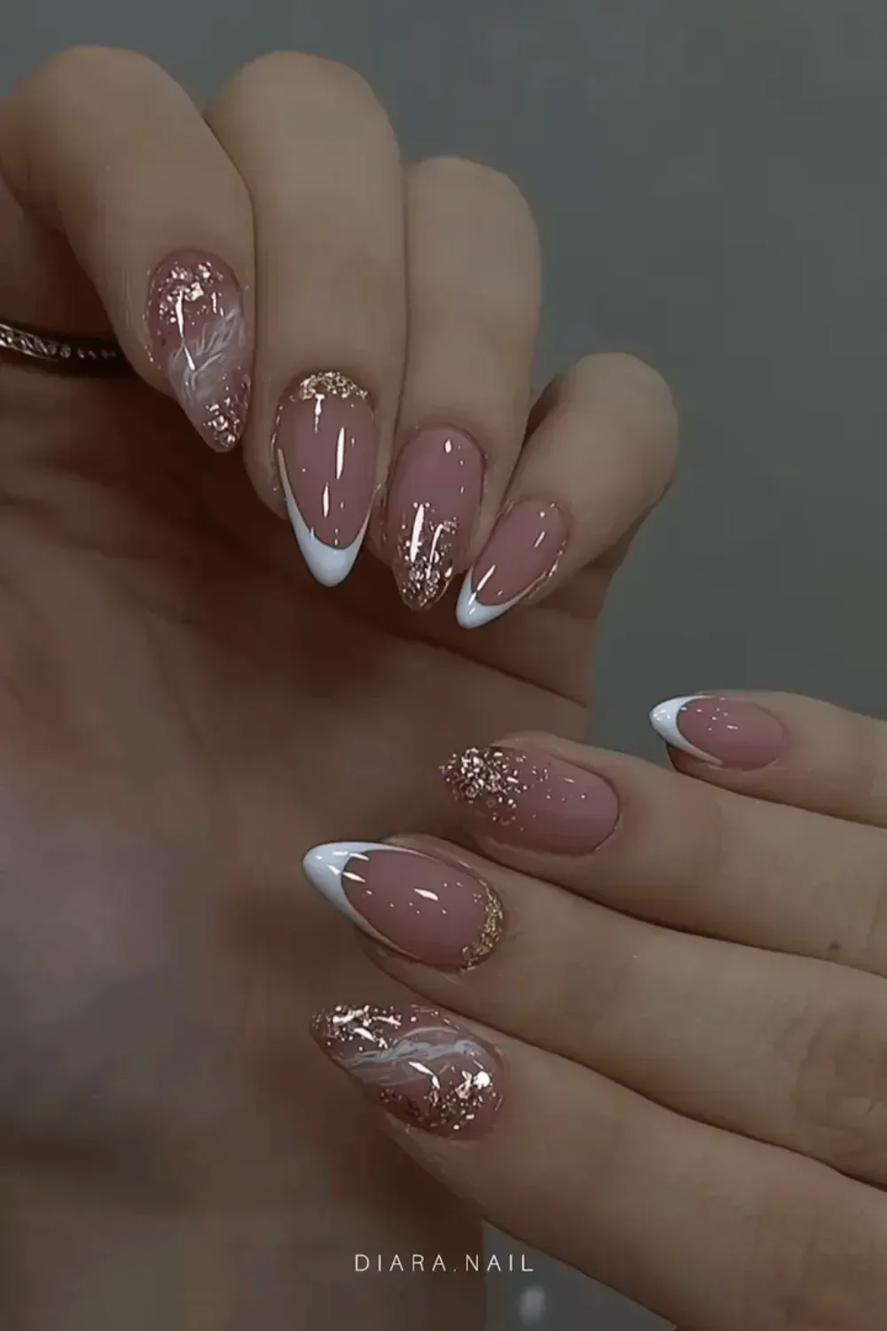 Silver Glitter French Manicure Alt Text: Almond nails with sparkling silver glitter french tips.