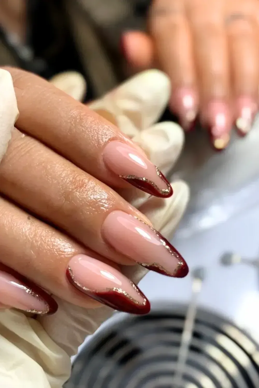 Autumnal Red & Gold Glitter Stiletto French: Stiletto nails with deep red French tips outlined in gold glitter.