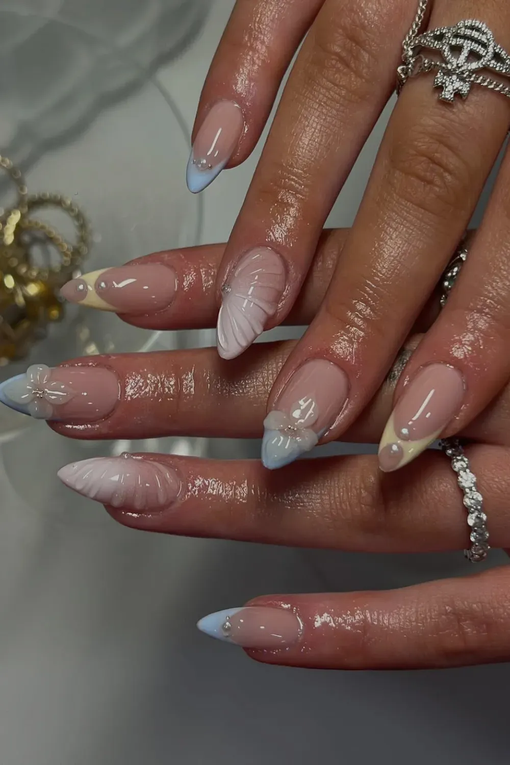 Mermaid Shell Texture Nails Alt Text: 3D shell texture french tips with pearls and ombre colors.