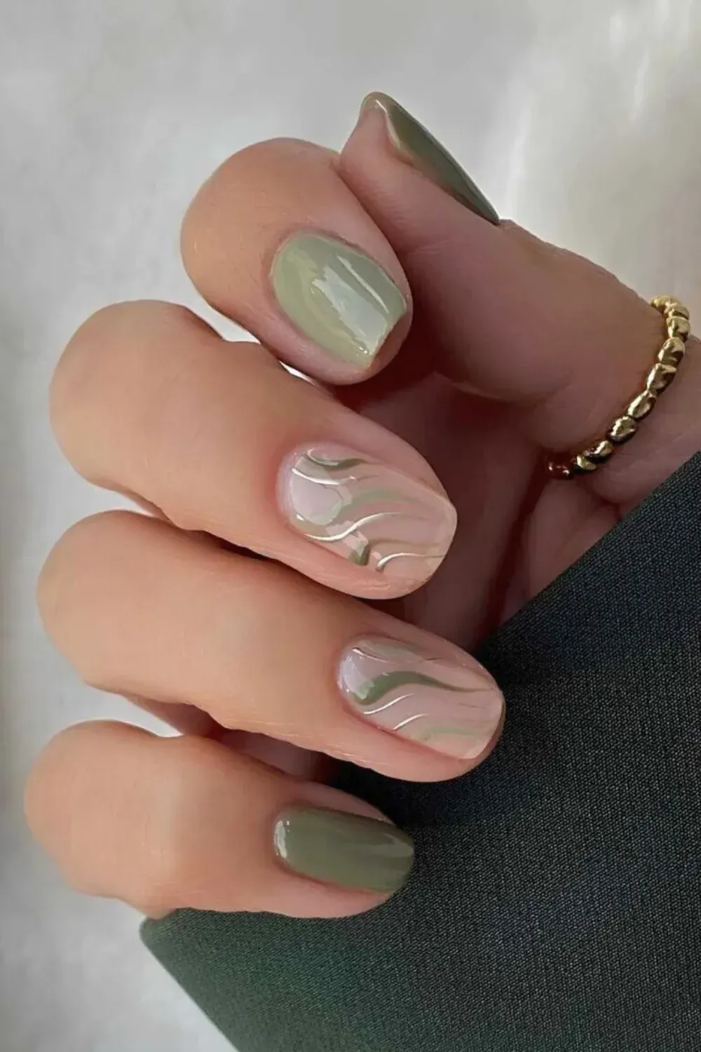 Sage Swirl Nails with Silver Chrome Line Art - Short squoval nails with light sage green swirls over pink, detailed with thin silver chrome lines.