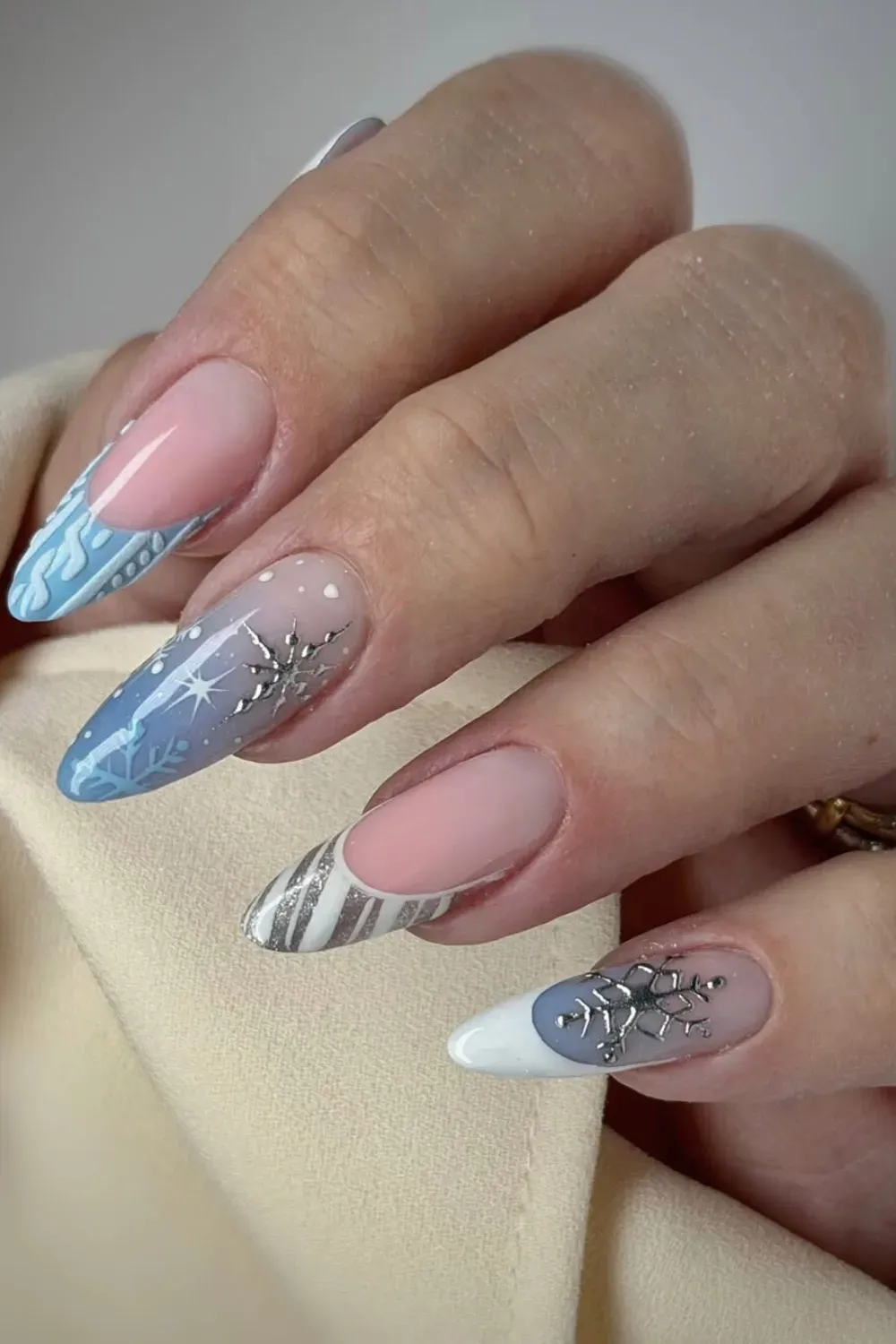 Winter Sweater French Nails Alt Text: Knit sweater texture nails with snowflakes and silver chrome.