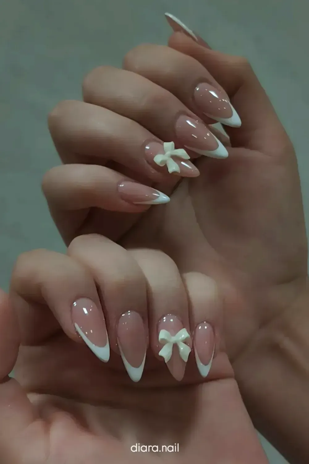 Delicate Bow Almond French: Almond nails with white French tips and charming 3D bow embellishments