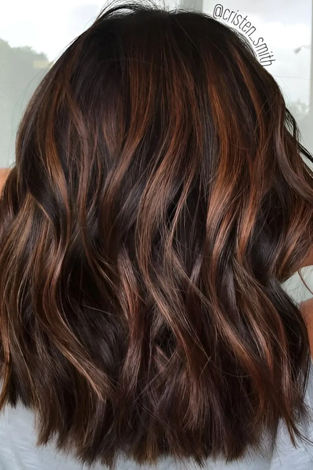 Rich Auburn Caramel Highlights on Wavy Lob	Back view of a wavy lob with rich, reddish-auburn caramel highlights woven into the dark base.