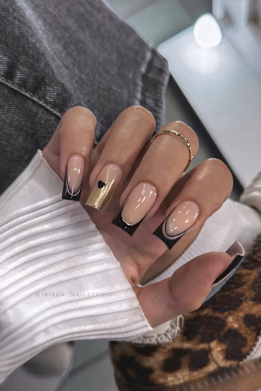 Black French With Heart Accent Alt Text: Black double french tip nails with gold chrome and black heart accent.