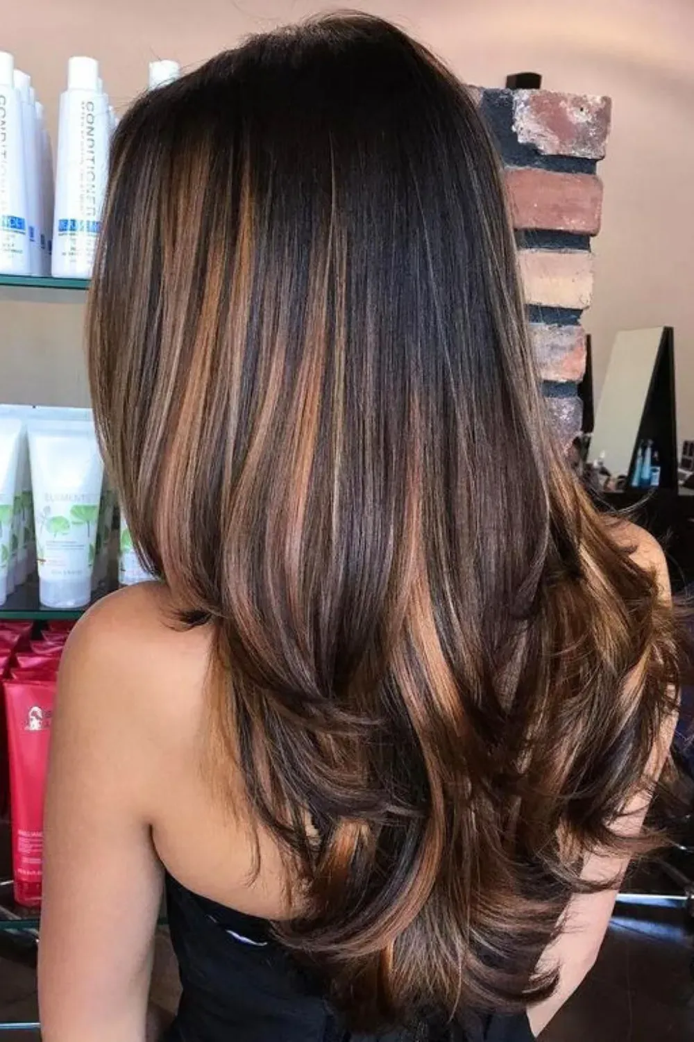 Thick Caramel and Blonde Balayage Ribbons	Back view of long, layered hair featuring thick, high-contrast caramel and blonde balayage streaks.