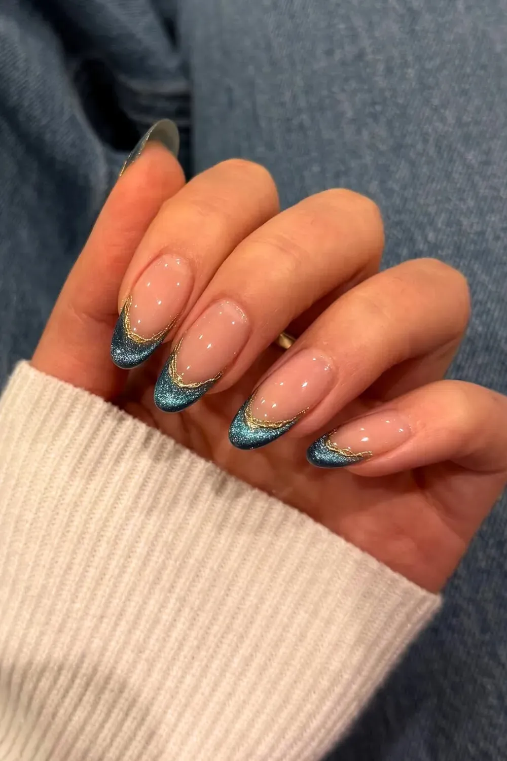 Mermaid Shimmer Blue & Gold French: Almond nails featuring a blue glitter French tip with a gold outline