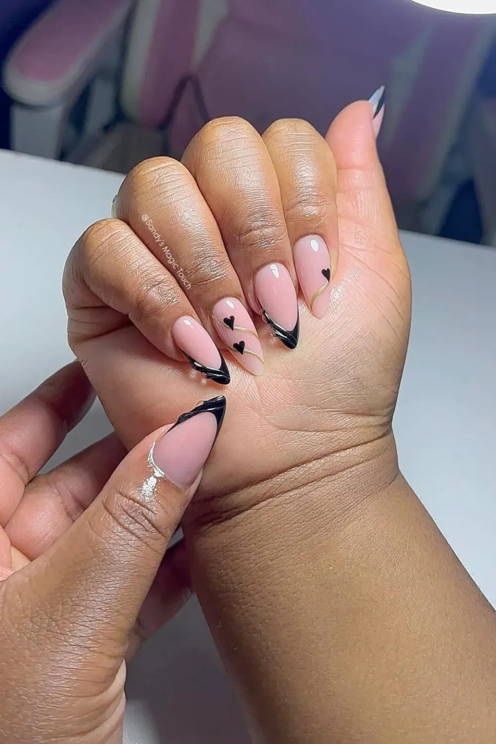 Sweet Black Heart Outline French: Almond nails with black French tips, a gold line, and tiny black heart accents