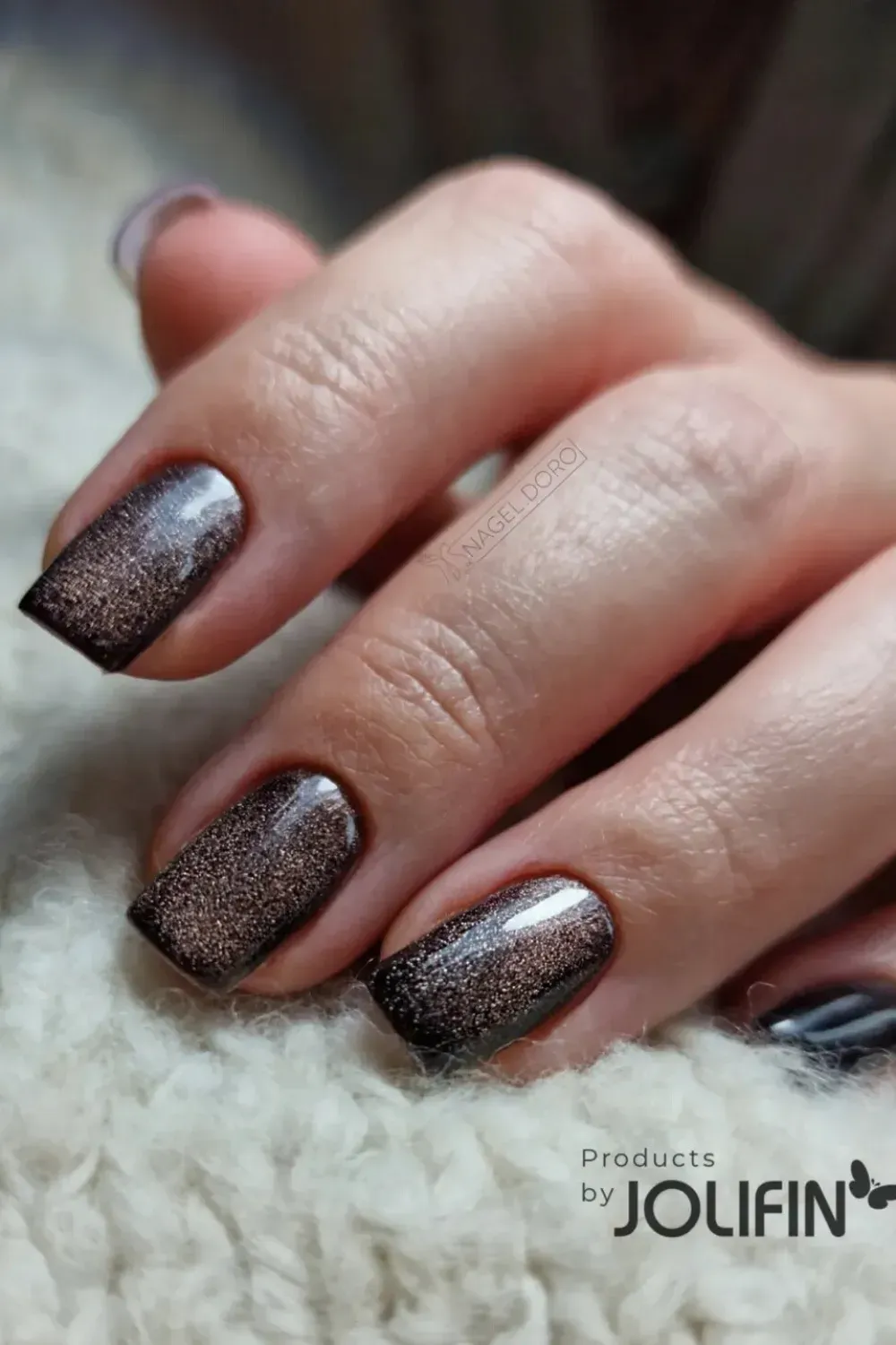 Textured dark bronze brown glitter cat eye nails on short length.