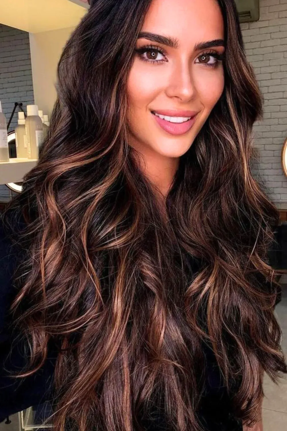 Glamorous Blended Balayage Waves	Woman with long, voluminous waves and high-dimension caramel-blonde balayage.