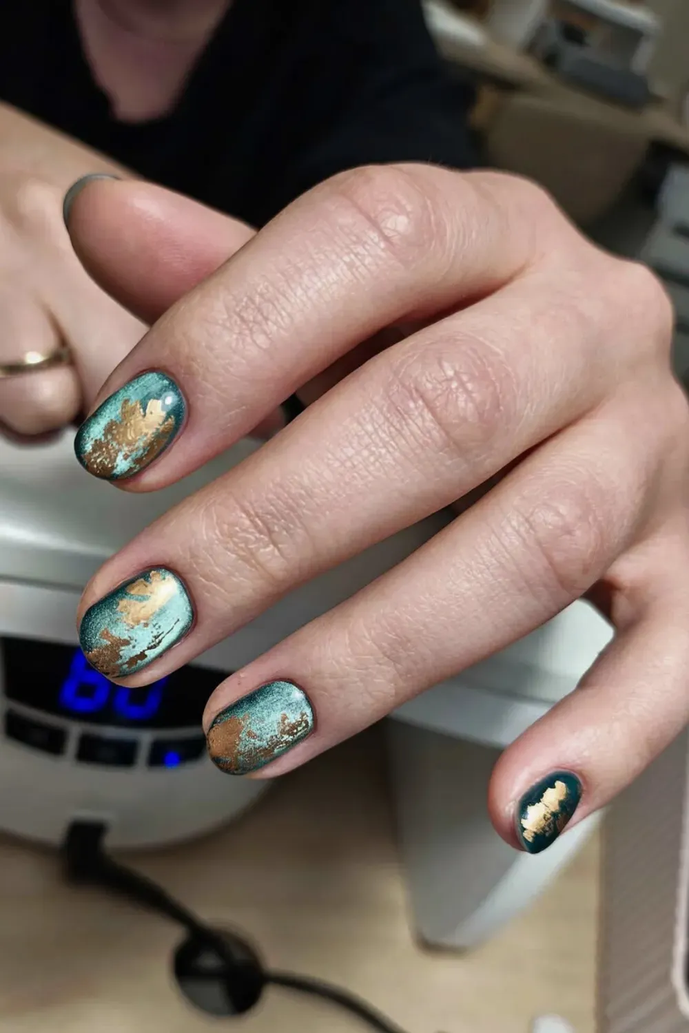 Matte turquoise nails with distressed gold foil magnetic patches on short length.