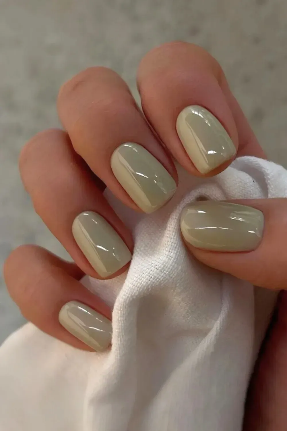 Solid Glossy Pistachio Green Nails - Short oval nails painted a solid, creamy, high-gloss pistachio green color.